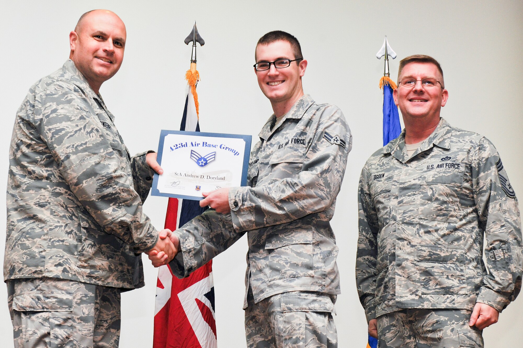 RAF ALCONBURY, United Kingdom – Airman 1st Class Andrew Doryland, 423rd Communications Squadron, receives his certificate for promotion to senior airman from Col. Steve Sweeney, 423rd Air Base Group commander, and Chief Master Sgt. Michael Ogden, 423rd ABG superintendent, during a promotion ceremony at RAF Alconbury Oct. 31. (U.S. Air Force photo by Staff Sgt. Brian Stives)