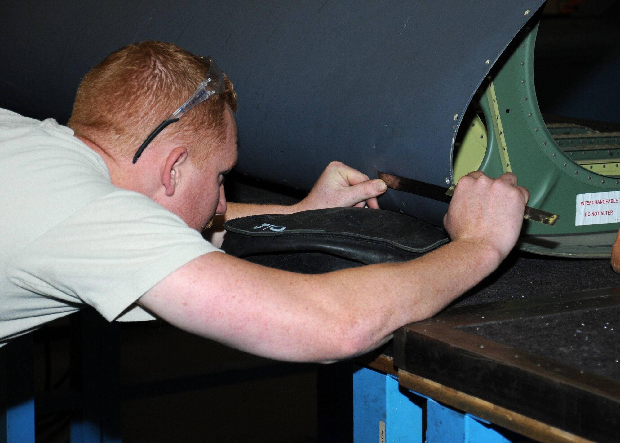 U.S. Air Force Staff Sgt. Zack Sidlovsky, 100th Maintenance Squadron aircraft maintenance craftsman from Naples, Fla., measures dent damage caused by a bird strike on a C-130J leading edge Oct. 25, 2013, on RAF Mildenhall, England. The 100th MXS aircraft maintenance shop personnel repair damages from an average of two to five bird strikes per year. The shop service members administer a corrosion control inspection program for 703 pieces of aerospace ground equipment valued at $18 million. (U.S. Air Force photo by Gina Randall/Released) 
