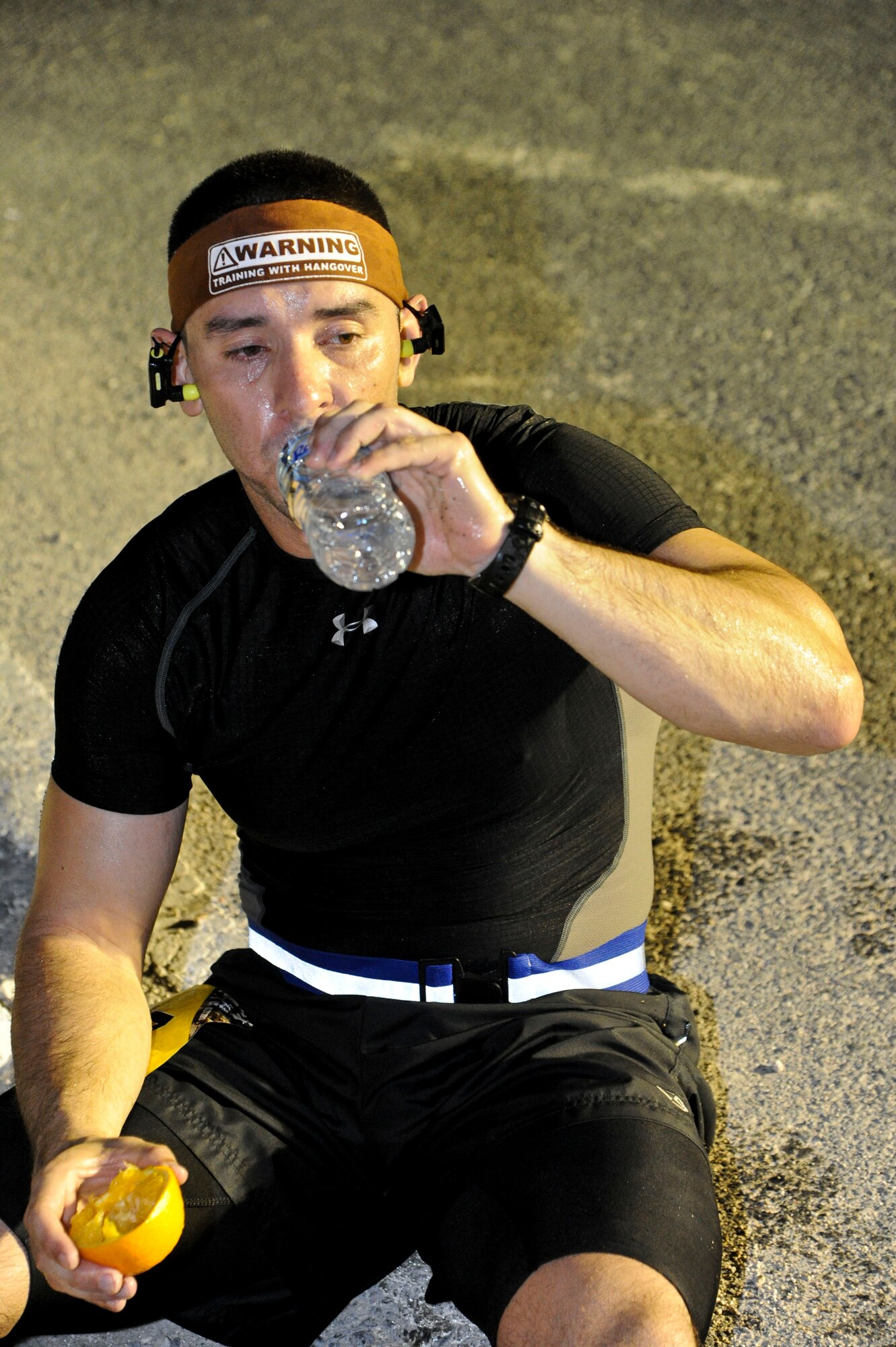 Capt. Ernesto Curiel drinks water after completing the Special Operations Command Central Forward Marine Corps Marathon at the 379th Air Expeditionary Wing in Southwest Asia, Oct. 27, 2013. Curiel completed the marathon at 3 hours and 26 minutes. The 26.2-mile run mirrored the 38th MCM held in Washington, D.C. Curiel is deployed from Lackland AFB, Texas and hails from Houston. (U.S. Air Force photo/Tech. Sgt. Joselito Aribuabo)