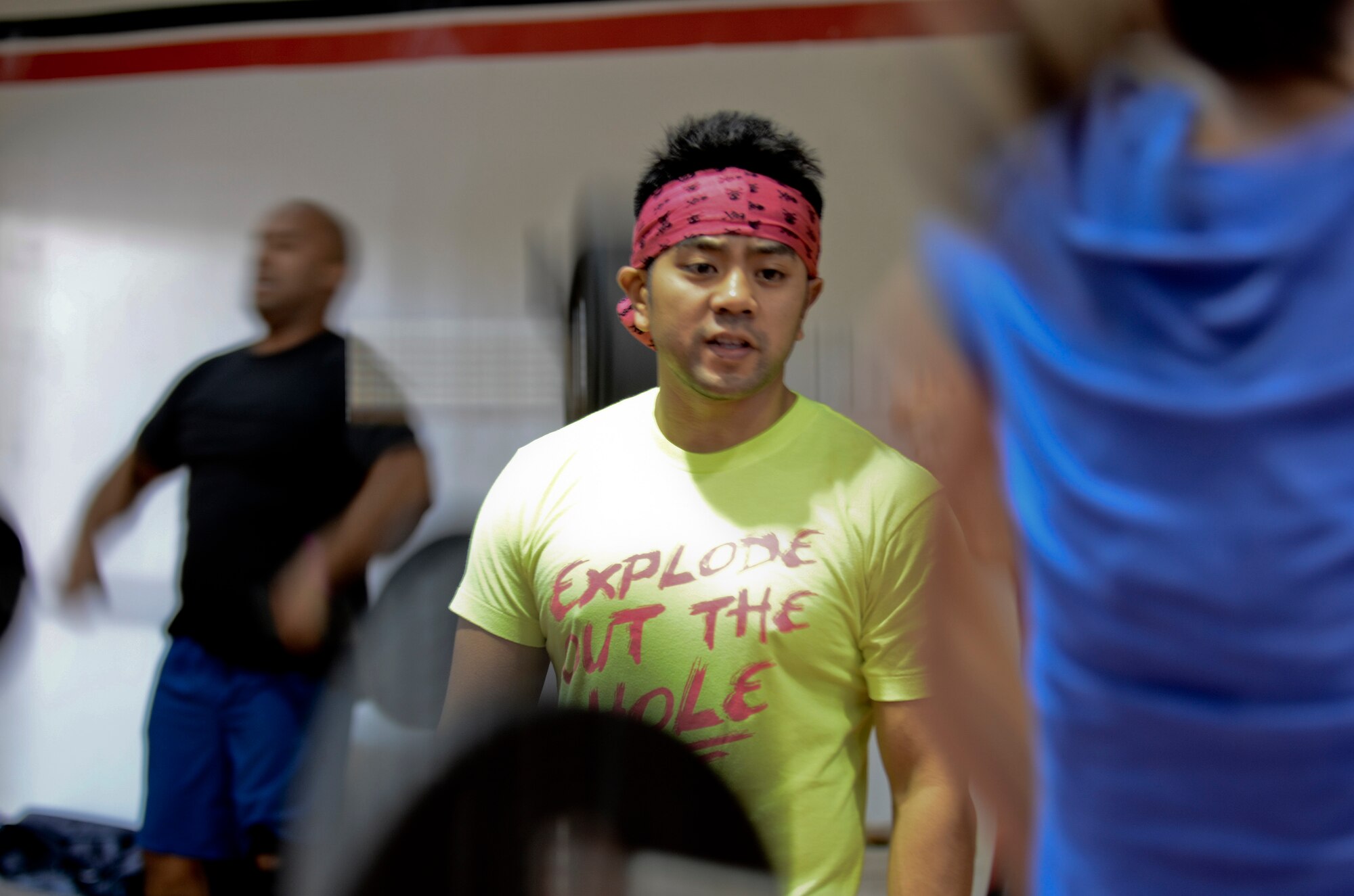 Tech. Sgt. Joseph McDowell, 736th Security Forces Squadron Contingency Response Flight chief, reminds participants to maintain proper form Oct. 26, 2013,  during the barbells for breast cancer awareness event at the Hot Spot on Andersen Air Force Base, Guam. More than 50 people signed up for the barbells for breast cancer awareness event and donated money to organizations that support earlier detection of the disease. (U.S. Air Force photo by Senior Airman Marianique Santos/Released)