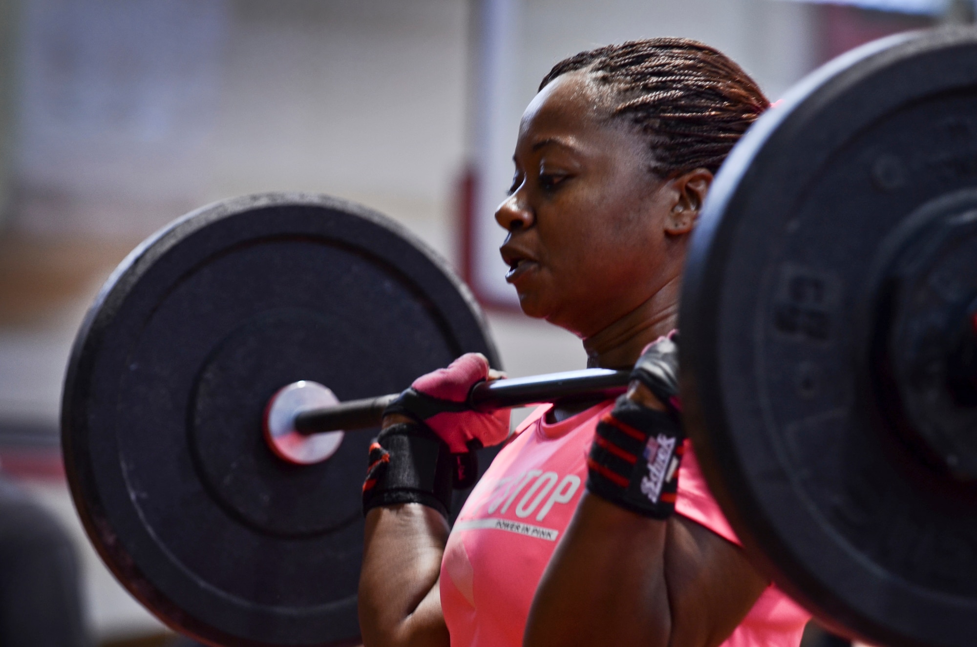 Capt. Musette Willis, 36th Wing Inspector General complaints resolution officer, performs a clean and jerk movement Oct. 26, 2013, during the barbells for breast cancer awareness event at the Hot Spot on Andersen Air Force Base, Guam. The clean and jerk movement involves lifting the bar from the ground to the shoulders and from shoulders to overhead.  (U.S. Air Force photo by Senior Airman Marianique Santos/Released)