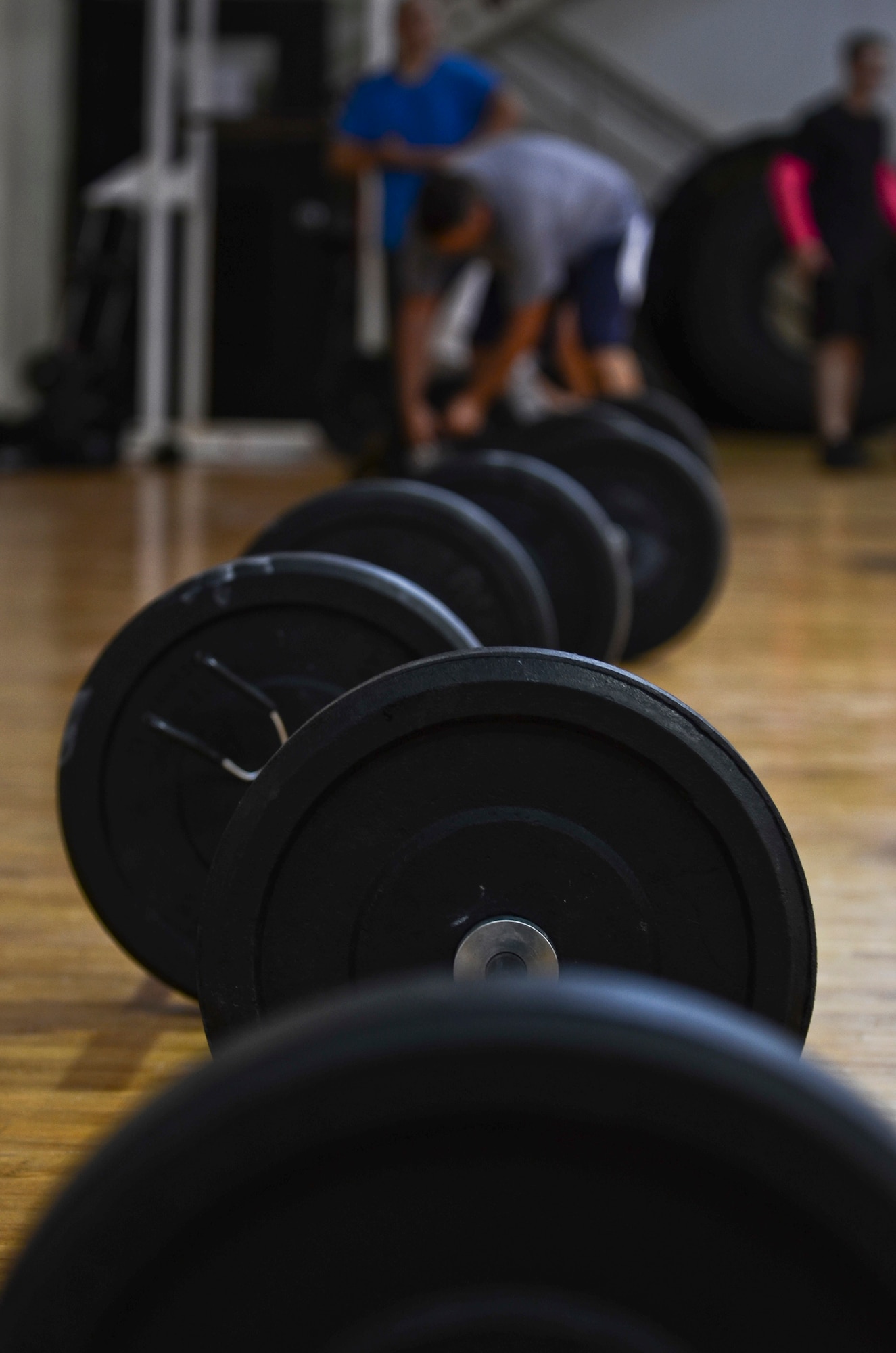 Barbells line the floor of the Hot Spot gym Oct. 26, 2013, as participants prepare for the barbells for breast cancer awareness event on Andersen Air Force Base, Guam. Participants aimed to complete 30 repetitions of the clean and jerk movement, which involves lifting the barbell from the ground to the shoulders and from shoulders to over the head and back down. More than 50 people signed up for the barbells for breast cancer awareness event and donated money to organizations that support earlier detection of the disease. (U.S. Air Force photo by Senior Airman Marianique Santos/Released)