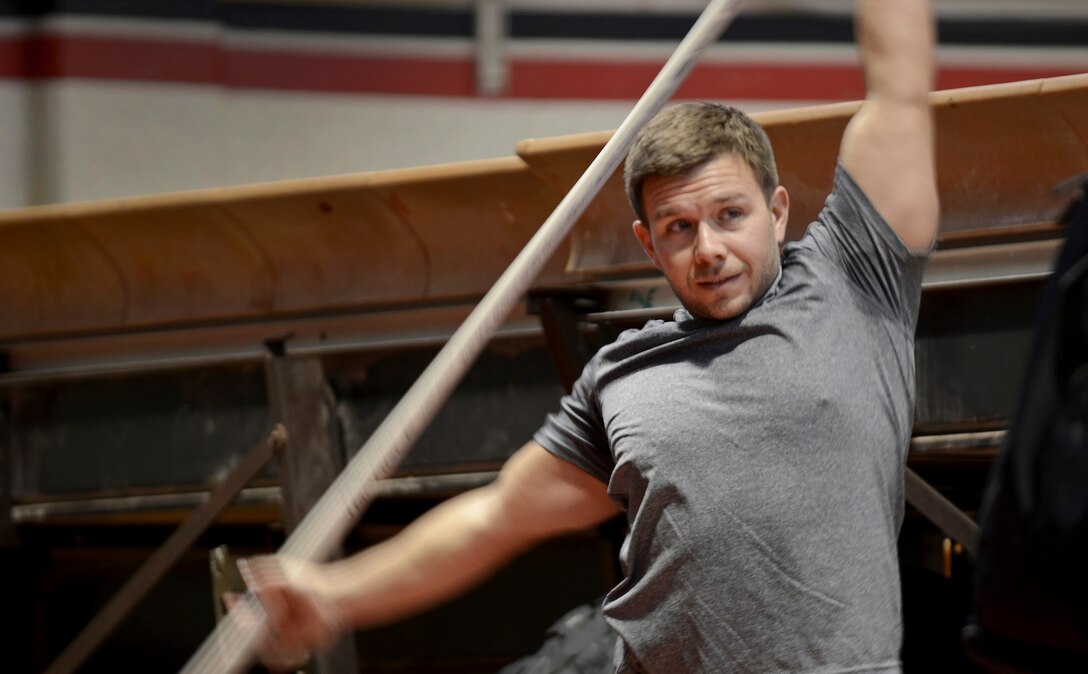 A member of Team Andersen stretches Oct. 26, 2013, before the barbells for breast cancer awareness event at the Hot Spot on Andersen Air Force Base, Guam. Participants did some heavy-duty lifting to raise breast cancer awareness and promote the importance of exercise in maintaining good health. (U.S. Air Force photo by Senior Airman Marianique Santos/Released)