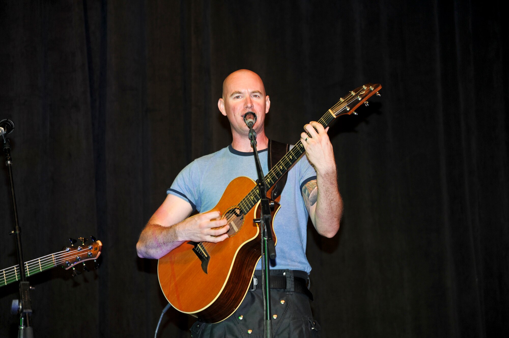 Staff Sgt. Jonathan Biccum plays the guitar during a performance at a local school in Southwest Asia, Oct. 28, 2013. The U.S. Air Forces Central Band’s mission is to positively promote troop morale, diplomacy and outreach to host nation communities. Biccum is a musician with the AFCENT Band and deployed from Travis Air Force Base, Calif., and is a native of New Glarus, Wis. (U.S. Air Force photo/Tech. Sgt. Joselito Aribuabo)