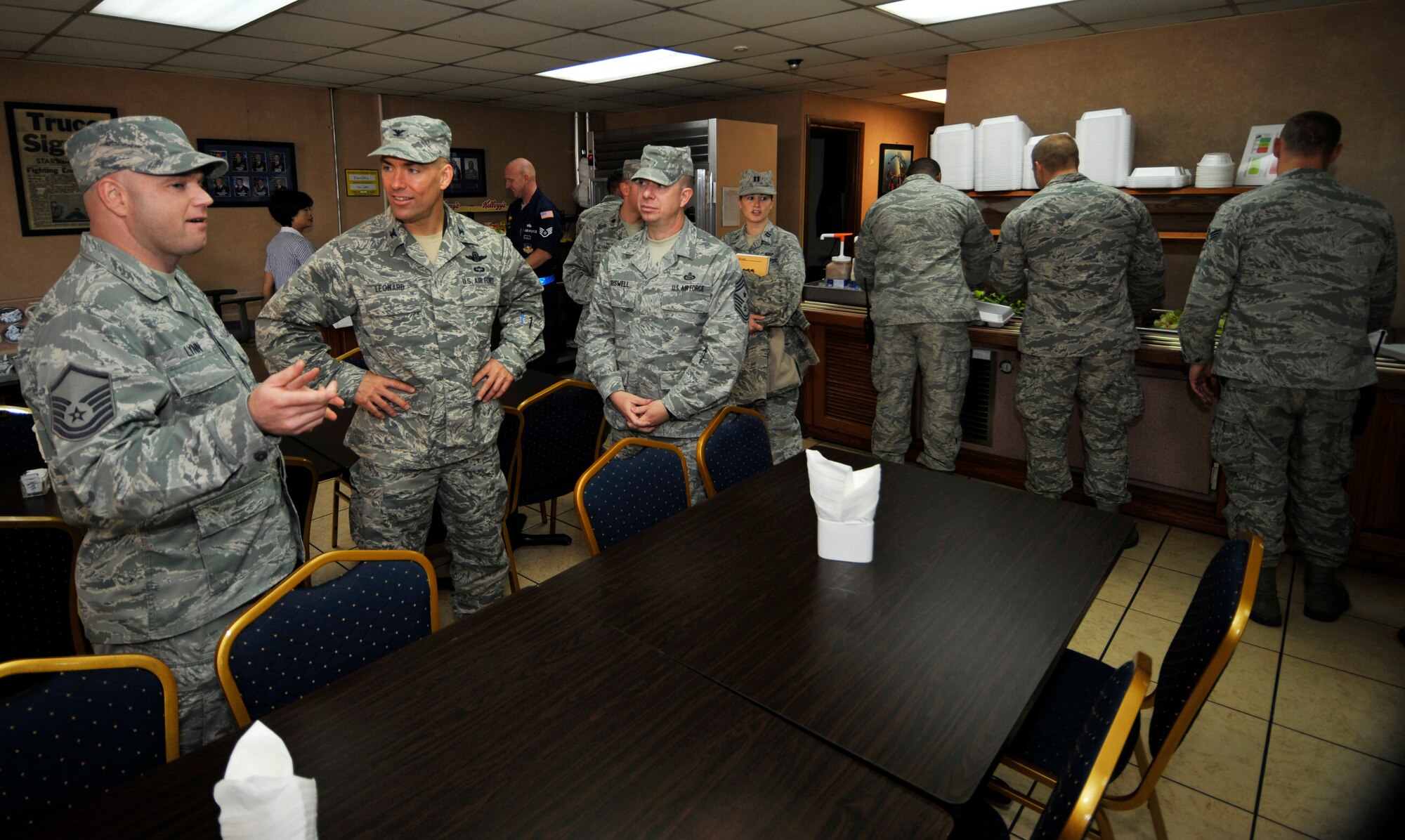 Master Sgt. Kenneth Lynn, 51st Force Support Squadron Back of the Hangar dining facility manager, gives Col. Brook Leonard, 51st Fighter Wing commander, and Chief Master Sgt. Brendan Criswell, 51st FW command chief, a tour of the dining facility at Osan Air Base, Republic of Korea, Oct. 31, 2013. The facility was built in 1986 and was renovated in 2001. (U.S. Air Force photo/Staff Sgt. Emerson Nuñez)