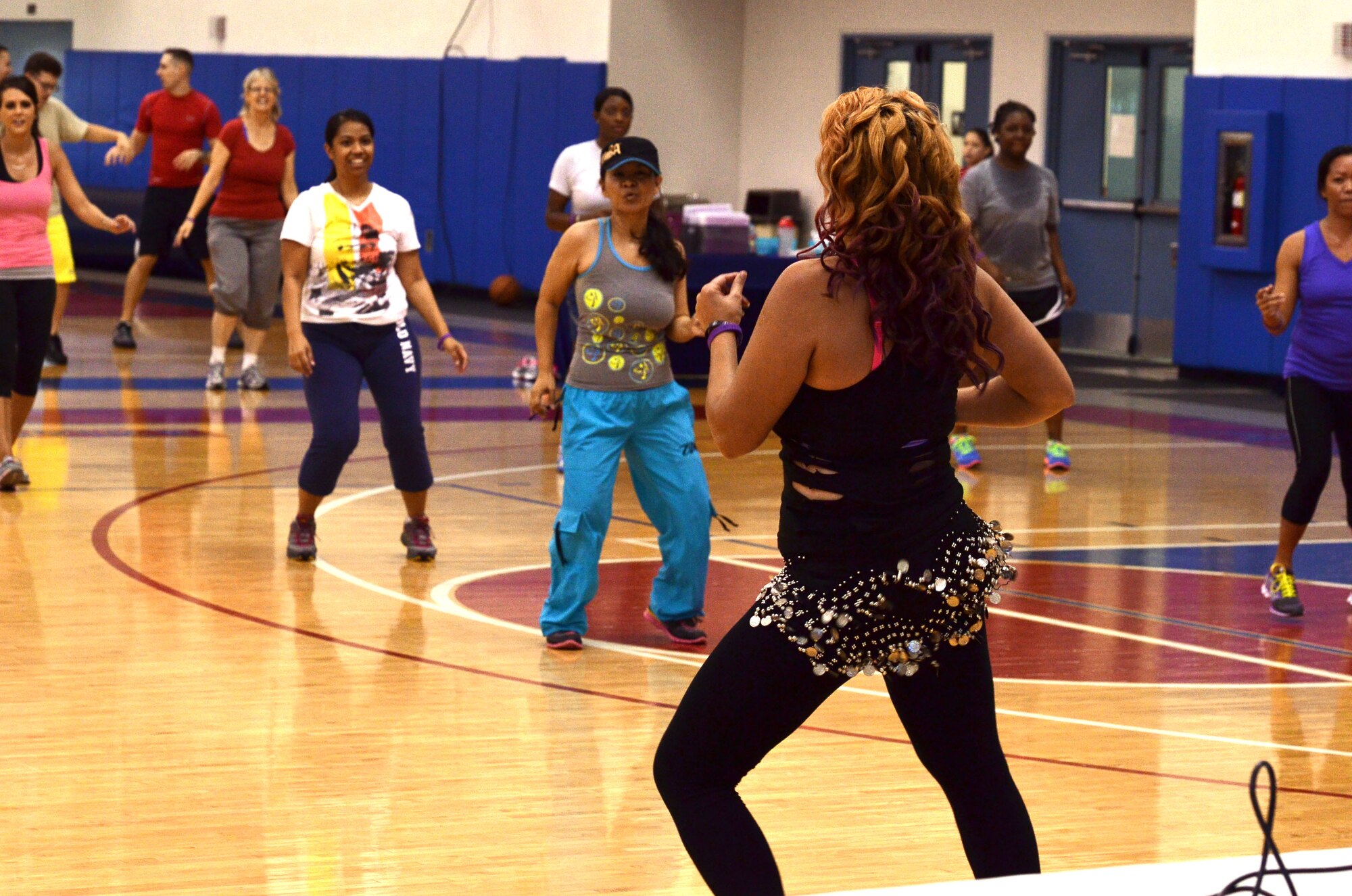 Members of Team Andersen participate in “Zumba Against Domestic Violence” at the Coral Reef Fitness Center on Andersen Air Force Base, Guam, Oct. 30, 2013. October is Domestic Violence Awareness Month and Andersen’s 36th Medical Operations Squadron Family Advocacy Program hosted the event and educated participants on domestic violence prevention and the signs of unhealthy or abusive relationships. (U.S. Air Force photo by Airman 1st Class Mariah Haddenham/Released)