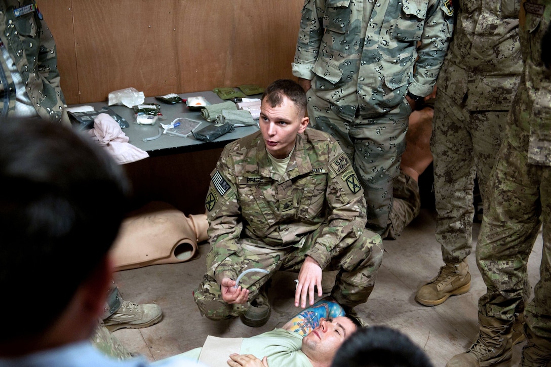 U.S. Army Sgt. Joshua Price, center, describes how to insert a nasopharyngeal airway tube into a casualty during a combat lifesaver class on Forward Operating Base Fenty in Afghanistan's Nangarhar province, Oct. 21, 2013. Price, a healthcare specialist, is assigned to the 10th Mountain Division's Company C, 94th Brigade Support Battalion, 4th Brigade Combat Team.