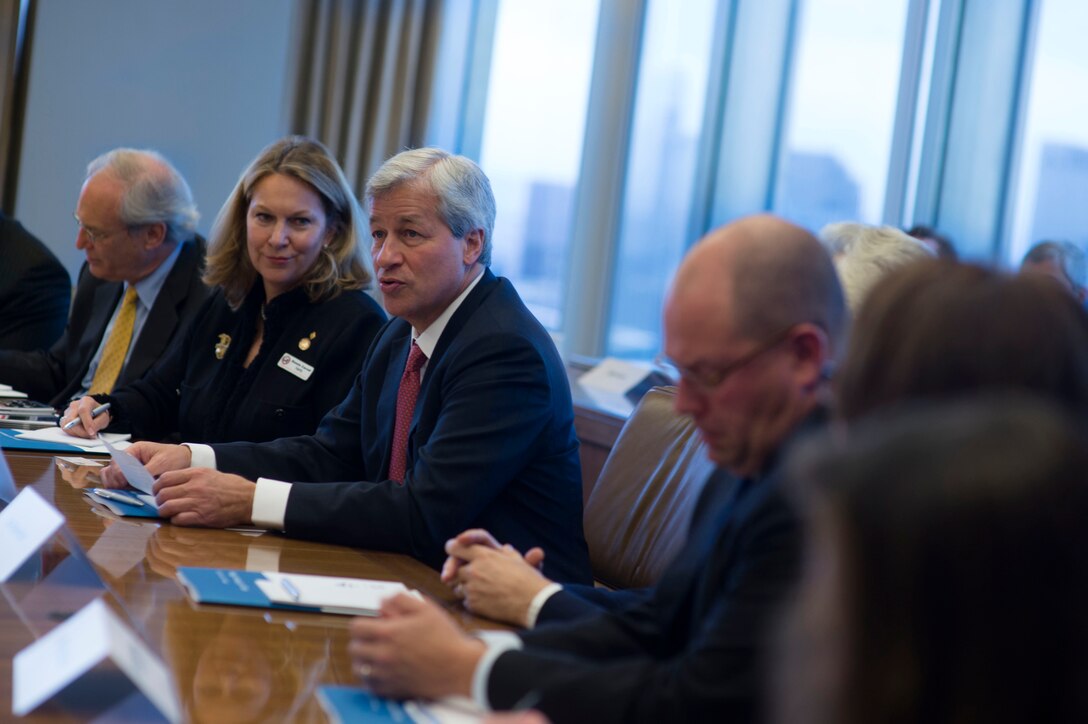 Jamie Dimon, third from left, CEO of J.P. Morgan Chase, welcomes Defense Secretary Chuck Hagel to a round table his company hosted with leaders of corporate and nonprofit veterans organizations in New York, Nov. 1, 2013.