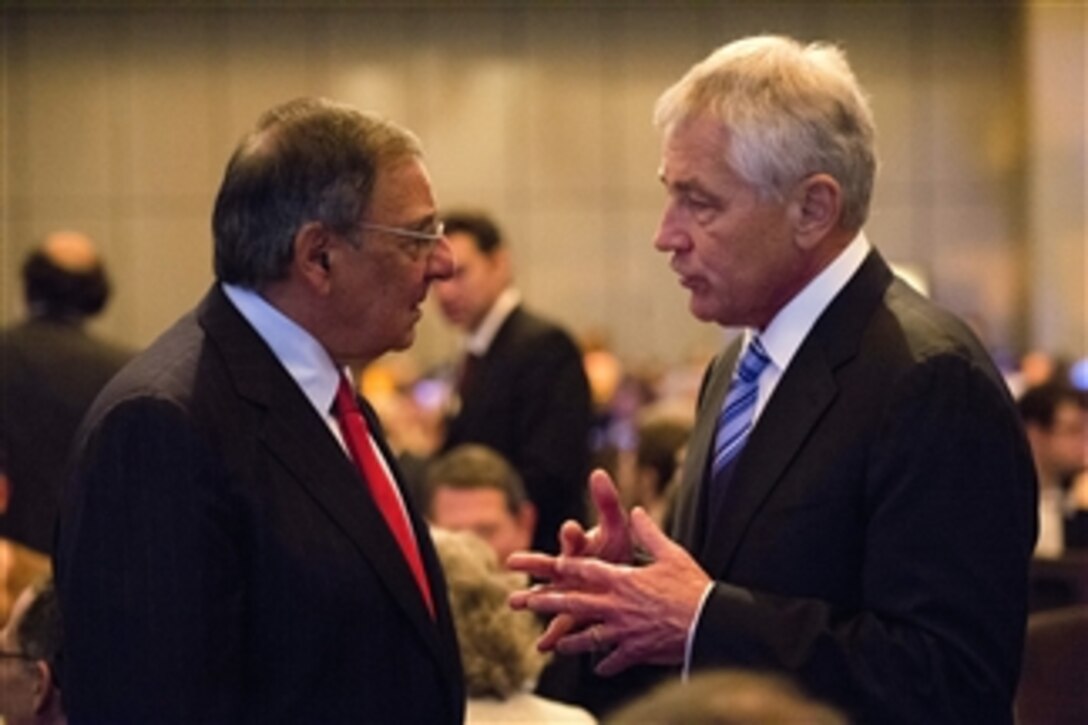 Secretary of Defense Chuck Hagel, right, talks with former Secretary of Defense Leon Panetta at the start of the centennial dinner for the Anti-Defamation League in New York, N.Y., on Oct 31, 2013.  Hagel later spoke to the audience on the repeal of the Defense of Marriage act and how currently five states are refusing to issue National Guard spouses of same-sex couples identification cards.  Hagel told the audience that he gave a directive to Chief of the National Guard Bureau Gen. Frank Grass to work with the states to follow the current law and issue the cards to same sex couples serving in the National Guard.   Panetta received the William and Naomi Gorowitz Institute Service Award for his dedication to equal rights throughout his career in public service during the ceremony.  