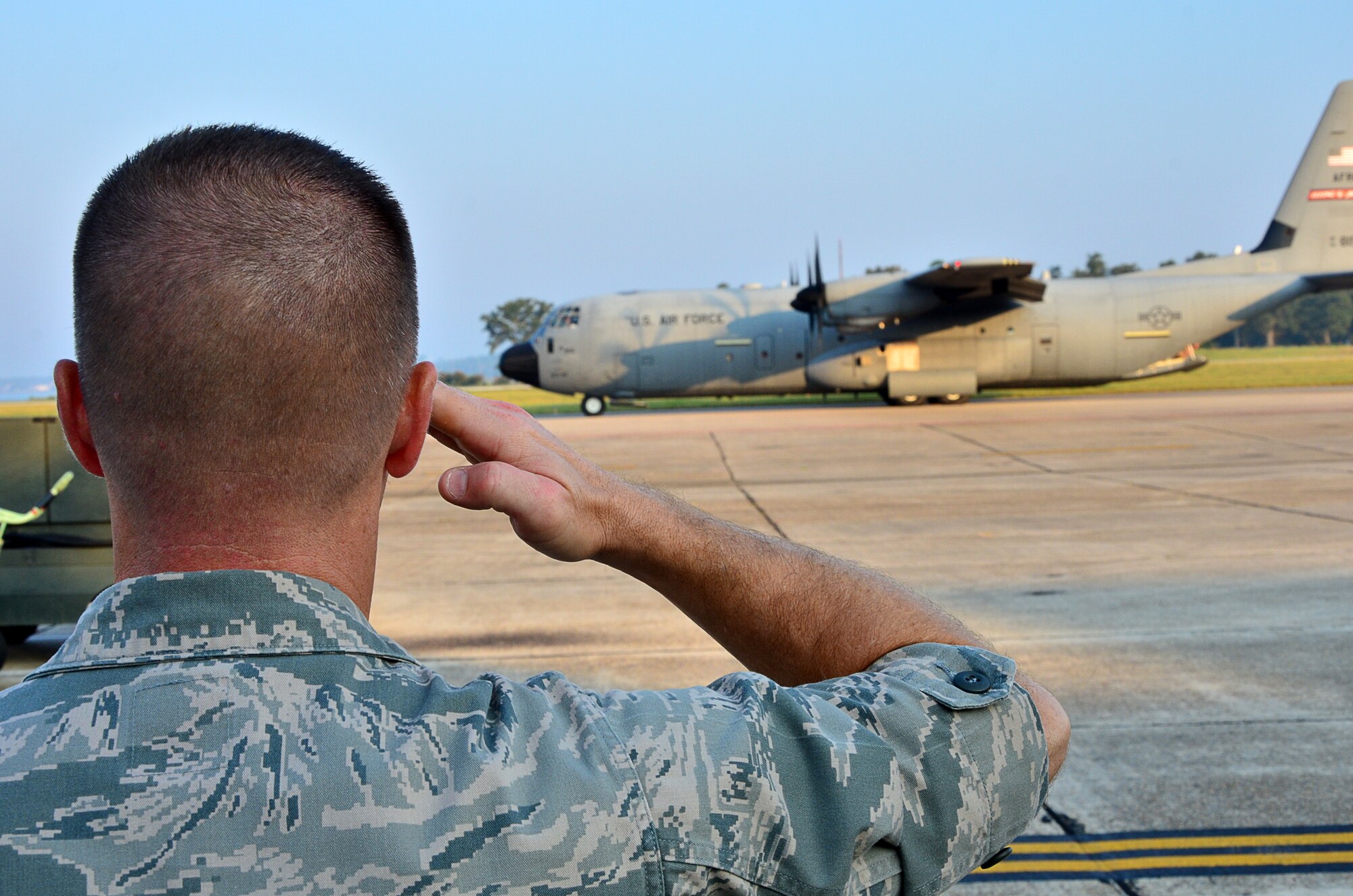 Col. Frank Amodeo, Commander of the 403rd Wing at Keesler Air Force Base, salutes goodbye to Airmen assigned to the 345th and 815th Airlift Squadrons as they prepare for takeoff on a deployment to support Airlift operations in Southwest Asia, Sept 9.