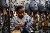Airman First Class Gabrielle Pearl, 442nd Logistics Readiness Squadron supply journeyman,checks the straps on a gas mask during issue of Chemicial, Biological, Radiological, Nuclear, Explosive defense equipment here on Nov. 2, 2013. Real-world M-50 gas masks were mass issued for training, in preparation for an upcoming deployment. The 442nd LRS is part of the 442nd Fighter Wing, an A-10 Thunderbolt II Air Force Reserve unit at Whiteman Air Force Base, Mo. (U.S. Air Force Photo/Senior Airman Wesley Wright) 