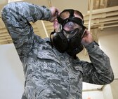 Senior Airman Jeremy Blaszczyk, 442nd Logistics Readiness Squadron supply journeyman, tests the fit on his gas mask during issue of Chemicial, Biological, Radiological, Nuclear, Explosive defense equipment here on Nov. 2, 2013. Real-world M-50 gas masks were mass issued for training in preparation of an upcoming deployment. The 442nd LRS is part of the 442nd Fighter Wing, an A-10 Thunderbolt II Air Force Reserve unit at Whiteman Air Force Base, Mo. (U.S. Air Force Photo/Senior Airman Wesley Wright) 