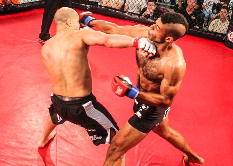 Danny Ruiz lands a knockout punch to Ryan Hodge in their bout at Strike Fight II Sept. 21 at Eglin Air Force Base, Fla. Ruiz won the fight minutes later. Ruiz is an Air Force reservist with the 919th Special Operations Logistics Readiness Squadron at Duke Field Fla. This was Eglin’s second mixed martial arts event. (Courtesy photo)