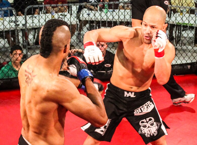 Danny Ruiz jabs at Ryan Hodge in their bout at Strike Fight II Sept. 21 at Eglin Air Force Base, Fla. Ruiz won by knockout in the first round. Ruiz is an Air Force reservist with the 919th Special Operations Logistics Readiness Squadron at Duke Field Fla. This was Eglin’s second mixed martial arts event. (Courtesy photo)