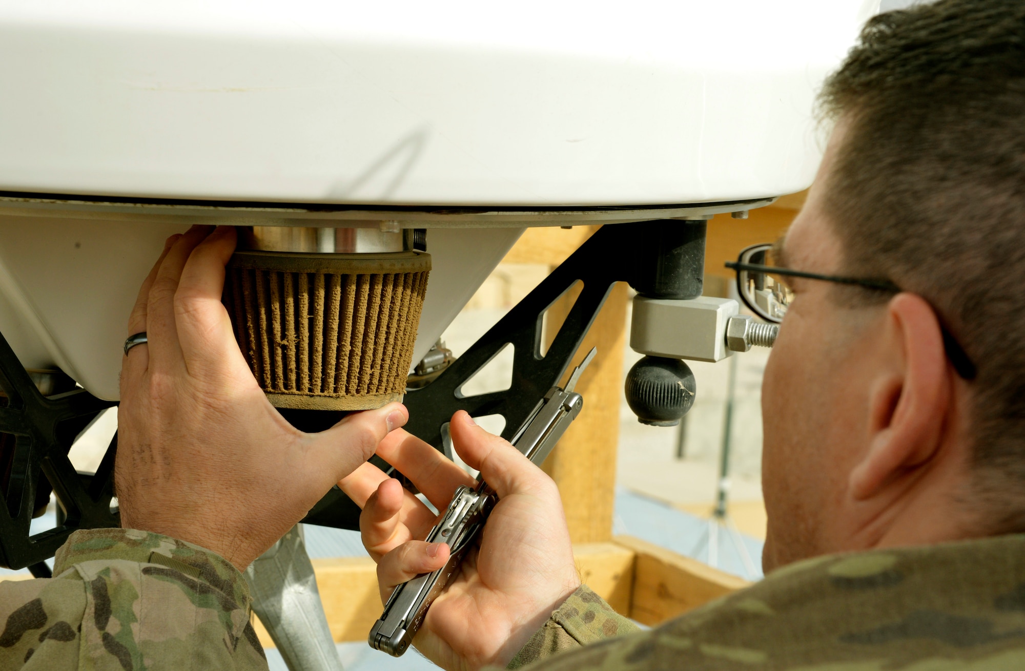 Master Sgt. Brian Landrum cleans a weather radar filter on Forward Operating Base Mazar-E-Sharif, Afghanistan. Because of the debris in the air here, the filters must be emptied and cleaned at least once a month to keep the radar running. Airmen assigned to the 19th Expeditionary Weather Squadron are embedded throughout Afghanistan with Army units. Landrum is deployed from Joint Base Lewis McCord, Wash., and a native of Temecula, Calif. (U.S. Air Force photo/ Staff Sgt. Stephenie Wade)