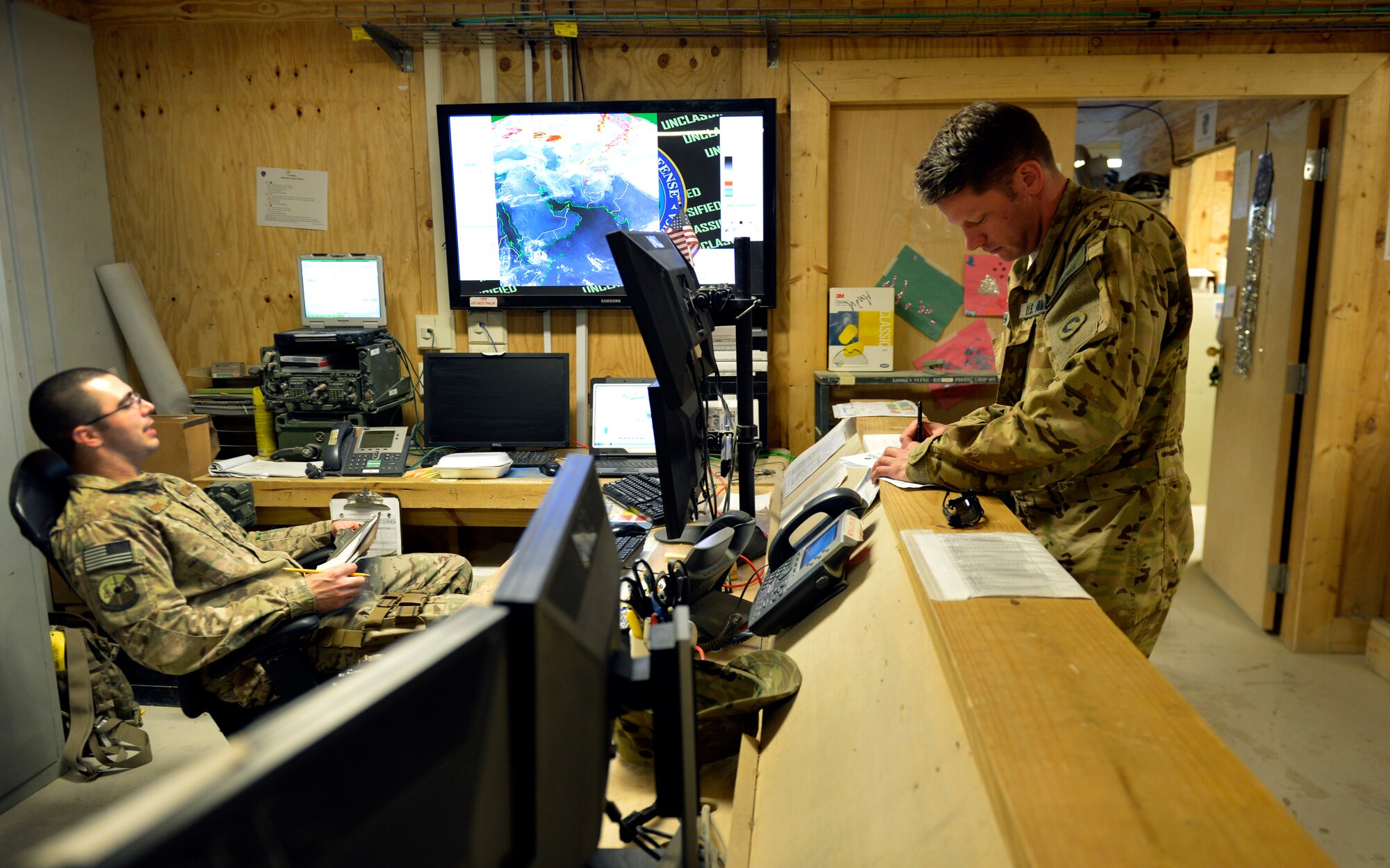Staff Sgt. Mickey Steppe, 19th Expeditionary Weather Squadron, battlefield weather forecaster, informs an Army pilot of the current weather conditions prior to take off on Forward Operating Base Mazar-E-Sharif, Afghanistan. Airmen assigned to the 19th Expeditionary Weather Squadron are embedded throughout Afghanistan with Army units. Steppe is deployed from Virginia Air National Guard Headquarters and a native of Richmond, Va. (U.S. Air Force photo/ Staff Sgt. Stephenie Wade)