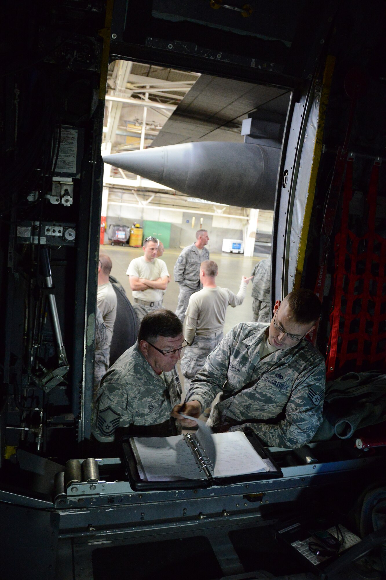 Master Sgt. Eric Peck, left, of the 103rd Maintenance Group, is introduced to a maintenance log for the unit’s newly-assigned C-130H Hercules by instructor Staff Sgt. Kurtis Franklin Friday, Oct. 25, 2013. This is the first out of eight C-130H model aircraft expected to be assigned to the 103rd Airlift Wing at Bradley Air National Guard Base, East Granby, Conn., and that the unit will operate in support of foreign and domestic airlift missions. (U.S. Air National Guard photo by Master Sgt. Erin E. McNamara) 