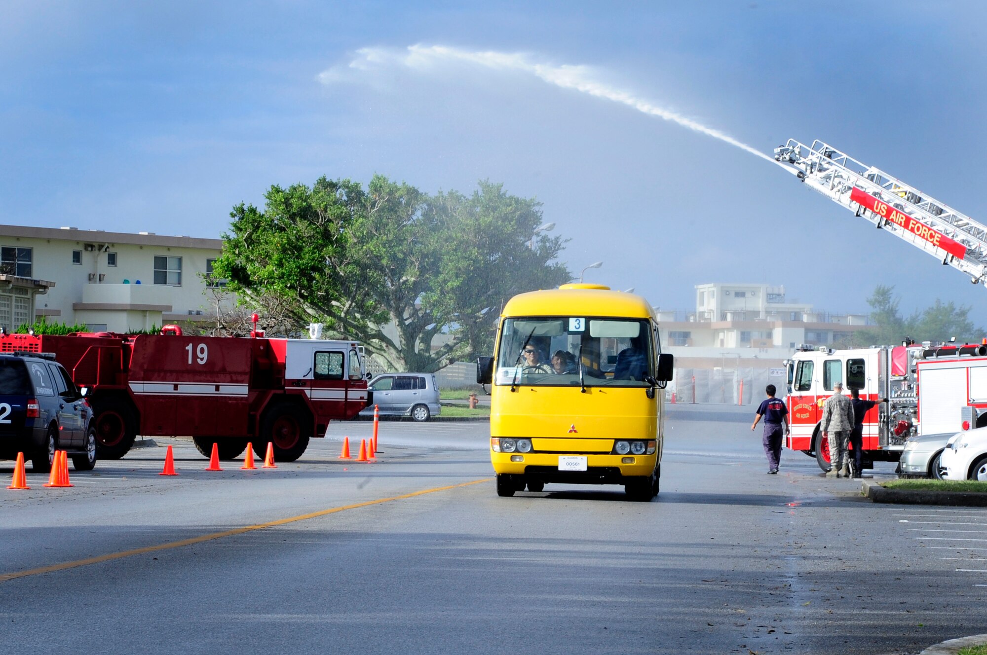 A fire engine sprays water over a bus of athletes during their arrival to the Kadena Special Olympics, Kadena Air Base, Japan, Nov. 2, 2013. The event is sponsored by the 18th Wing and the Friends of Kadena Special Olympics in partnership with the Okinawa Prefectural Government, Okinawa City, Kadena Town, Chatan Town and all U.S. military services on island. (U.S. Air Force photo by Staff. Sgt. Darnell T. Cannady)