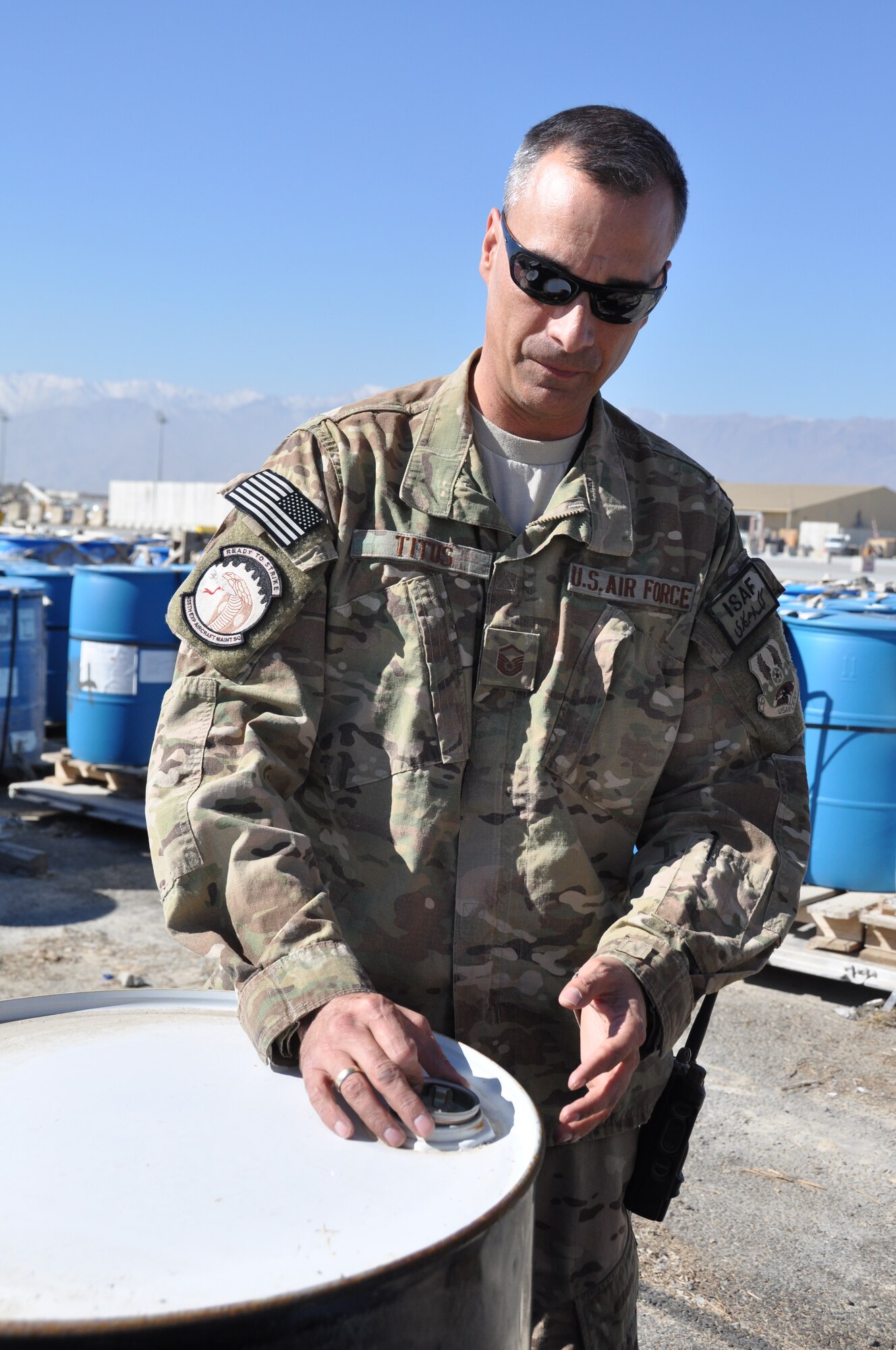 Master Sgt. Paul Titus, 455th Expeditionary Aircraft Maintenance Squadron production superintendent, a native of Denver, Colo., who’s deployed from Seymour Johnson Air Force Base, N.C., discusses how Glycol, a commercial, non-toxic de-icing fluid used to prevent the buildup of ice storage, is stored on Bagram Airfield, Afghanistan, Nov. 2, 2013. (U.S. Air Force photo/Tech. Sgt. Rob Hazelett)