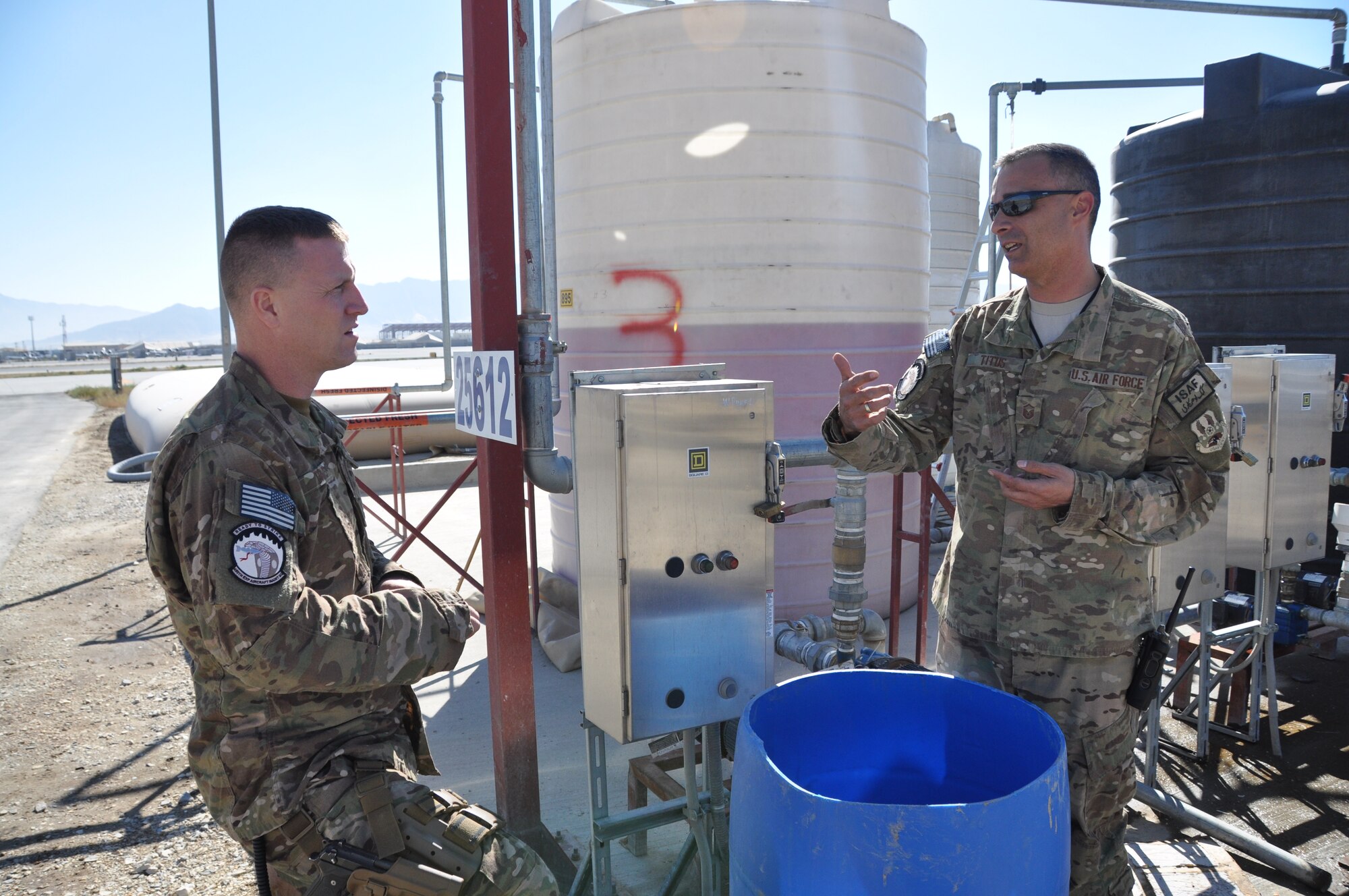 Master Sgt. Paul Titus, a native of Denver, Colo., talks with Master Sgt. Andrew Davis, a resident of Moscow, Tenn., on Bagram Airfield, Afghanistan, Nov. 2, 2013. Both are 455 EAMXS production superintendents who have deployed from Seymour Johnson Air Force Base, N.C. (U.S. Air Force photo/Tech. Sgt. Rob Hazelett)
