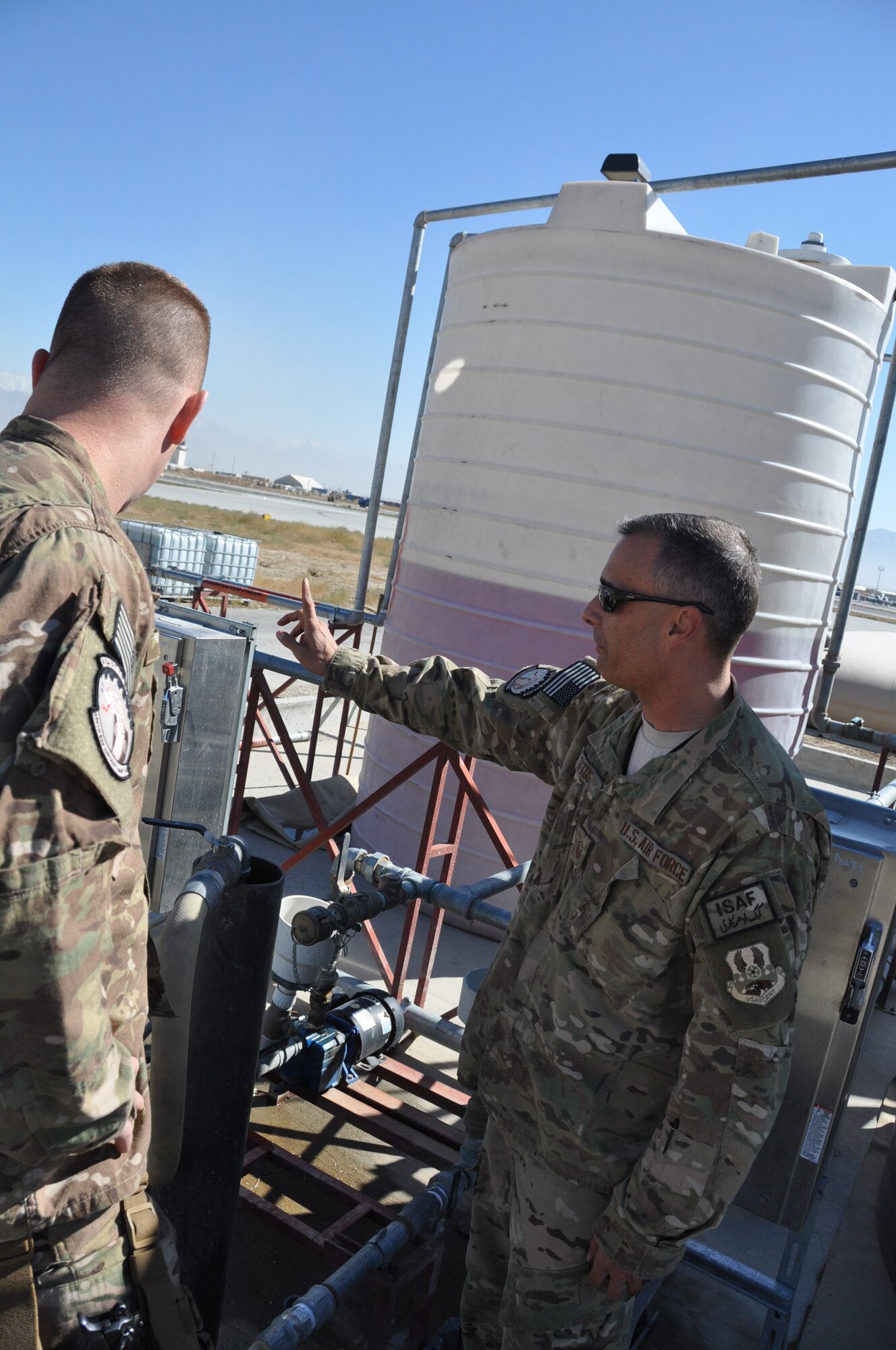 Master Sgt. Paul Titus, 455th Expeditionary Aircraft Maintenance Squadron production superintendent, a native of Denver, Colo., who’s deployed from Seymour Johnson Air Force Base, N.C., discusses how to operate the Glycol tanks on Bagram Airfield, Afghanistan, Nov. 2, 2013. Glycol is a commercial, non-toxic de-icing fluid used to prevent the buildup of ice. (U.S. Air Force photo/Tech. Sgt. Rob Hazelett)