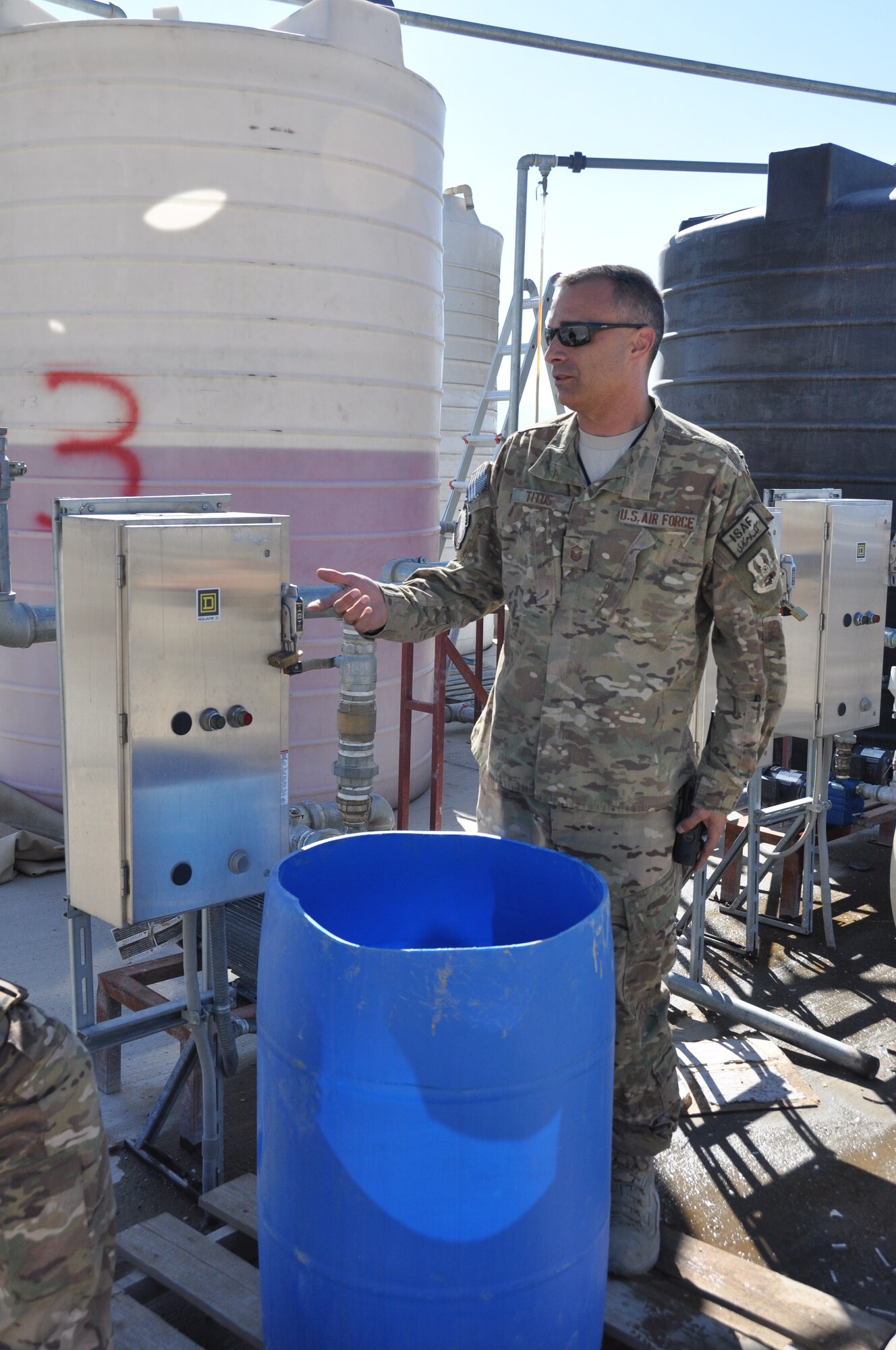 Master Sgt. Paul Titus, 455th Expeditionary Aircraft Maintenance Squadron production superintendent, a native of Denver, Colo., who’s deployed from Seymour Johnson Air Force Base, N.C., discusses how to operate the Glycol tanks on Bagram Airfield, Afghanistan, Nov. 2, 2013. Glycol is a commercial, non-toxic de-icing fluid used to prevent the buildup of ice. (U.S. Air Force photo/Tech. Sgt. Rob Hazelett)