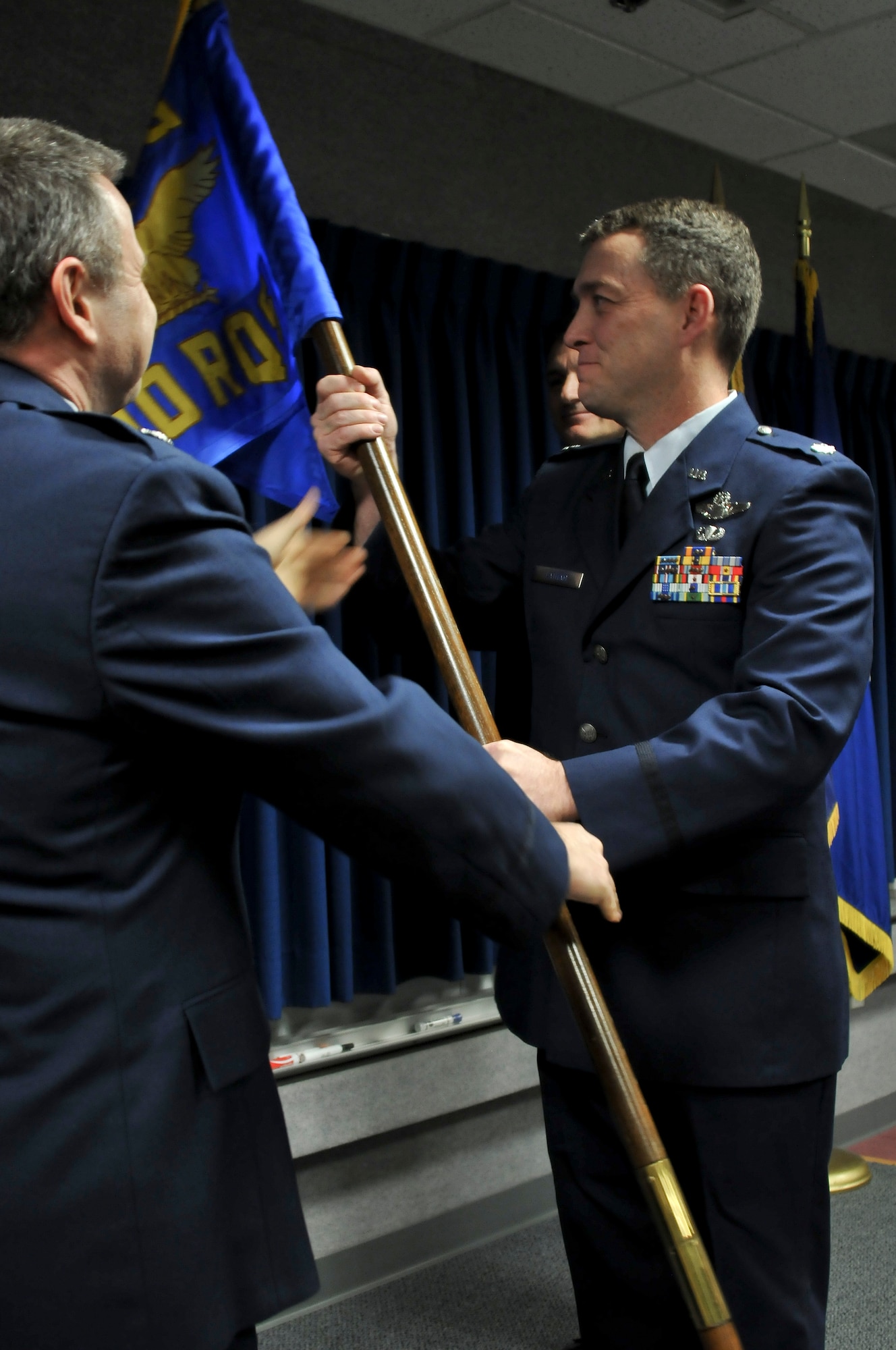 JOINT BASE ELMENDORF-RICHARDSON, Alaska -- Lt. Col. Steven Latham takes command of the 210th Rescue Squadron from Lt. Col. Thomas Bolin here Nov. 3 at a change of command ceremony. Latham accepted the unit flag from Lt. Col. Michael Griesbaum, 176 Operations Group deputy commander, as a symbol of his new leadership position. National Guard photo by Staff Sgt. N Alicia Halla/ Released.
