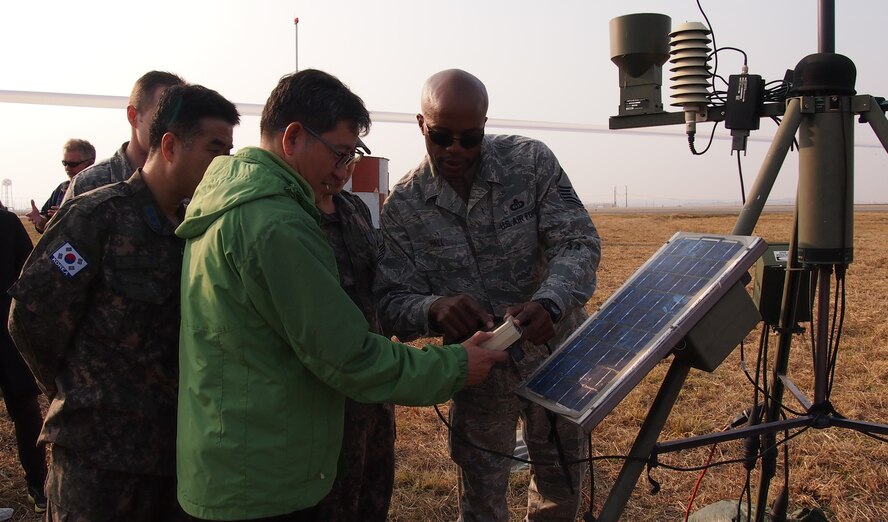 U.S. ARMY GARRISON HUMPHREYS, Republic of Korea - Master Sgt. Charles Hall, Det. 2, 607th Weather Squadron detachment chief, shows a member of the Korean Meteorological Administration how to use at Tactical Meteorological Observing System on the U.S. Army Garrison Humphreys flightline, Nov. 1., as part of an open house Det. 2 hosted for the Republic of Korea Weather Wing and KMA. (U.S. Air Force photo by Tech. Sgt. Thomas J. Doscher)