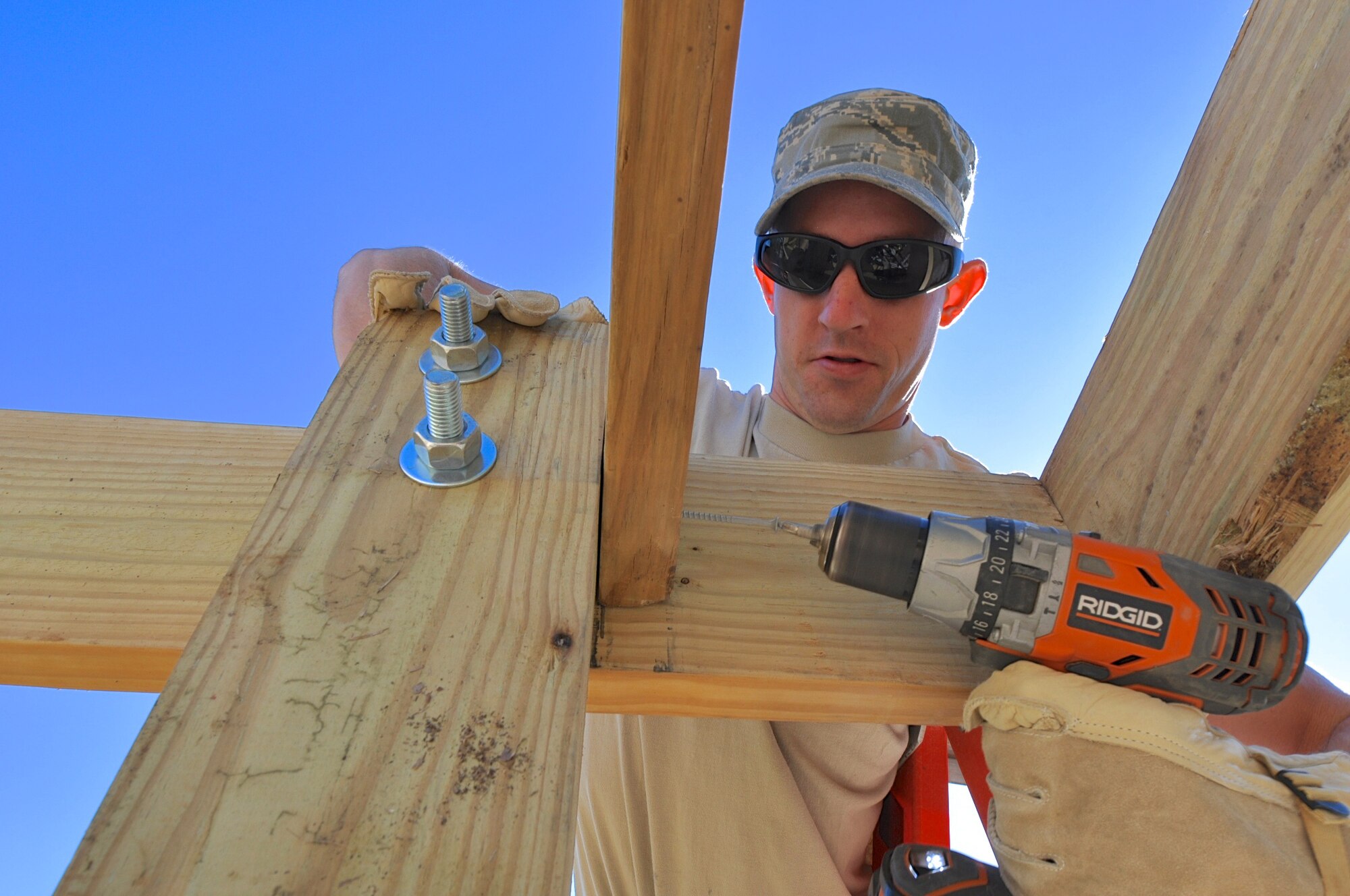 Senior Airman Cody Seymore, a structural journeyman with the 403rd Civil Engineering Squadron, works with his team to complete the squadron's BBQ Pit cover. The new BBQ Pit cover was funded from the funds received from Keesler winning the Commander and Chief Installation Excellence Selection Board Award in 2012.