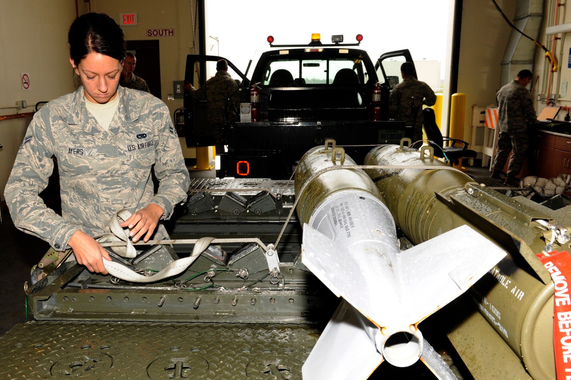 131102-Z-EZ686-168 Airman 1st Class Brianna Ayers, 127th Maintenance Squadro,n secures two test bombs for transportation at Selfridge Air National Guard Base, Mich., Nov. 2, 2013. Ayers said she finds her work challenging and enjoys what she does. (U.S. Air National Guard photo by MSgt. David Kujawa/Released)