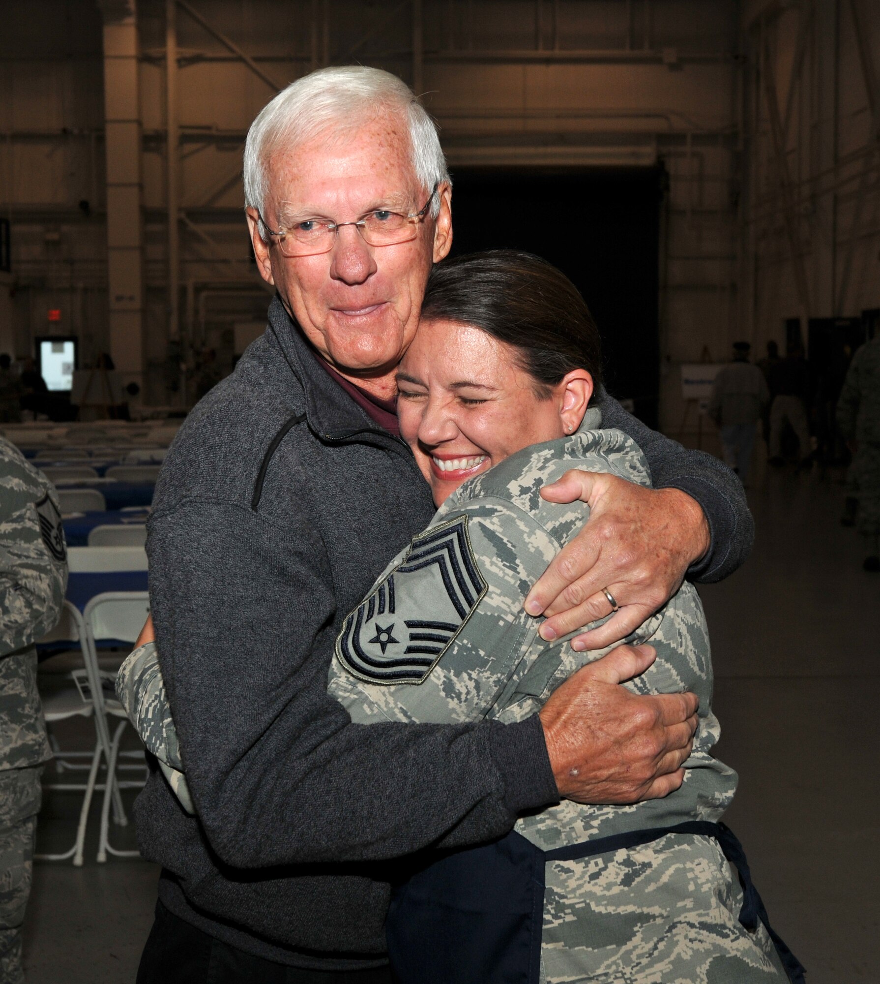 U.S. Air Force Chief Master Sgt. Susan A. Dietz, 145th Medical Group, gives a big hug to retired Lt. Col. Phil Carrigan, former member of the 145th Mission Support Flight, North Carolina Air National Guard, at the 18th Annual Retiree Breakfast held in a hanger at the North Carolina Air National Guard base, Charlotte Douglas Intl. Airport, Friday, Oct. 25, 2013. (Air National Guard photo by Master Sgt. Patricia F. Moran/Released) 