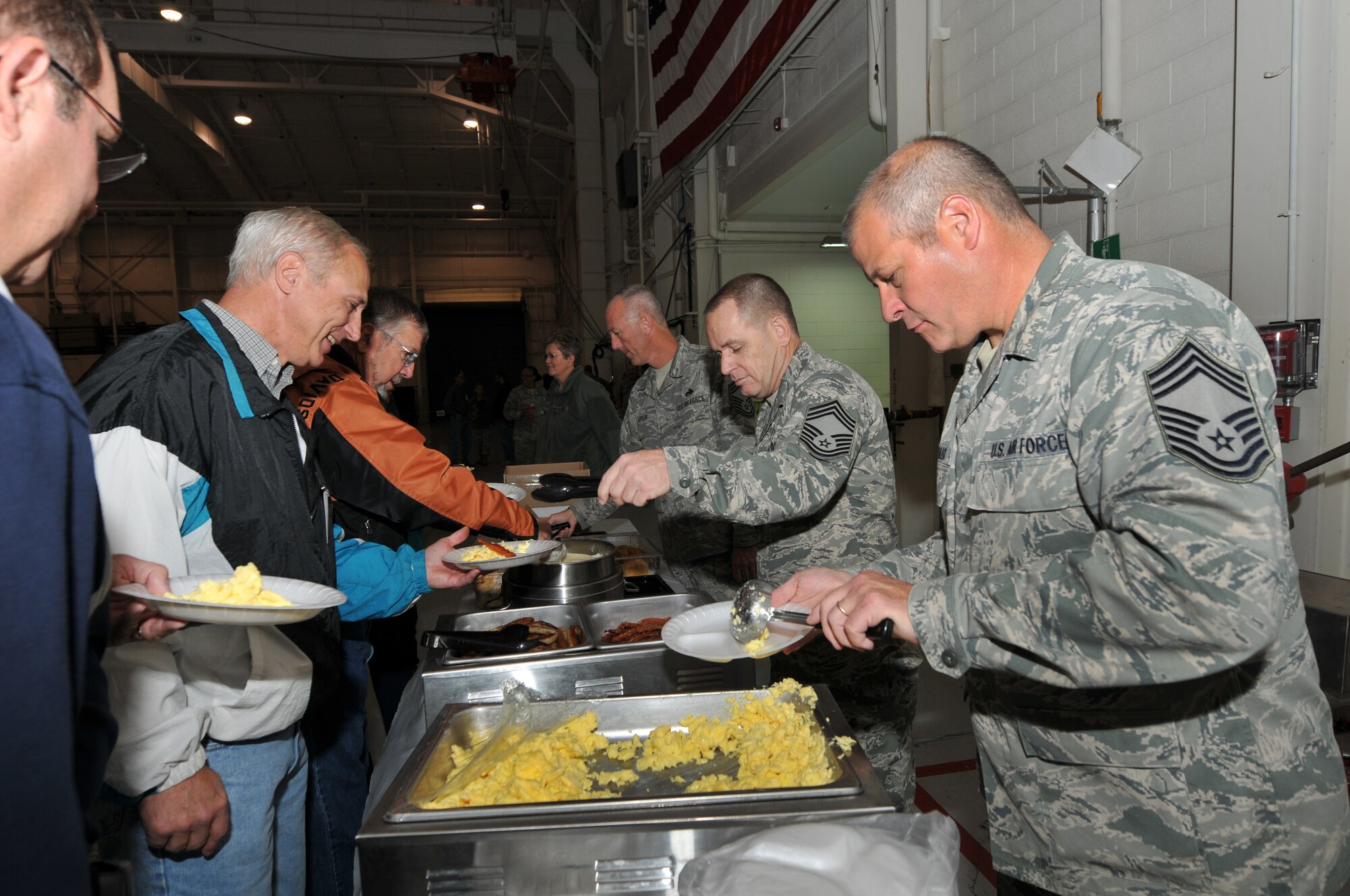U.S. Air Force Chief Master Sgt. Ritchie L. Stiller, 145th Communication Squadron, along with other chiefs from the North Carolina Air National Guard, serve breakfast to retirees at the 18th Annual Retiree Breakfast held in a hanger at the North Carolina Air National Guard base, Charlotte Douglas Intl. Airport, Friday, Oct. 25, 2013. (Air National Guard photo by Master Sgt. Patricia F. Moran/Released) 