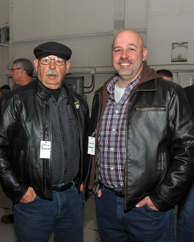 After serving 24 years in the 145th Security Forces Squadron, retired Master Sgt. Charles A. Bramwell, Sr. stands with son Senior Master Sgt. Charles A. Bramwell, Jr., who retired this year from the 145th Logistics Readiness Squadron, as they reminisce with other retirees at the 18th Annual Retiree Breakfast held in a hanger at the North Carolina Air National Guard base, Charlotte-Douglas Intl. Airport.  Bramwell, Jr. proudly stated, “Dad has been my most constant figure in my life.  In 1997 I received the Air Combat Command Maintenance Professional of the Year award. When I flew home from Lajes Field, Azores, I went straight to Security Forces where Dad was working and with his peers and friends present; I told him that I won the award not because what I had done but because of what he had done in teaching and leading me.  I then gave the Maintenance Man Trophy to him. I have always stated that if I am half as great as my Dad is, then I will be a success.  He has always been my measuring stick and role model.”  When asked what they like to do together now that they are both retired Bramwell simply stated, “We like to eat together!” (Air National Guard photo by Master Sgt. Patricia F. Moran/Released)