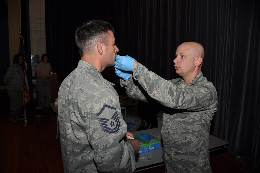Capt. Kevin Kosal, 914th Aeromedical Staging Squadron, issues Master Sgt. Bryan Mathers, 30th Aerialport Squadron, the flu mist, Nov. 2, 2013. The flu vaccination is imperative to Airmen to avoid seasonal illness and remain "fit to fight." (U.S. Air Force photo by Staff Sgt. Stephanie Clark) 