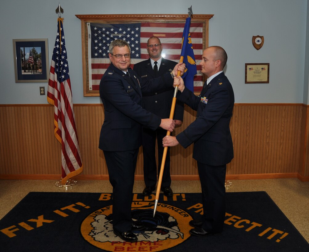 Col. Alan Teauseau, 914th Mission Support Group commander, hands the 914th Civil Engineer Squadron flag over to Maj. Matthew Heinsler as part of a traditional military ceremony symbolizing the assumption of command by Heinsler, November 2, 2013. (U.S. Air Force photo by Staff Sgt. Stephanie Clark) 