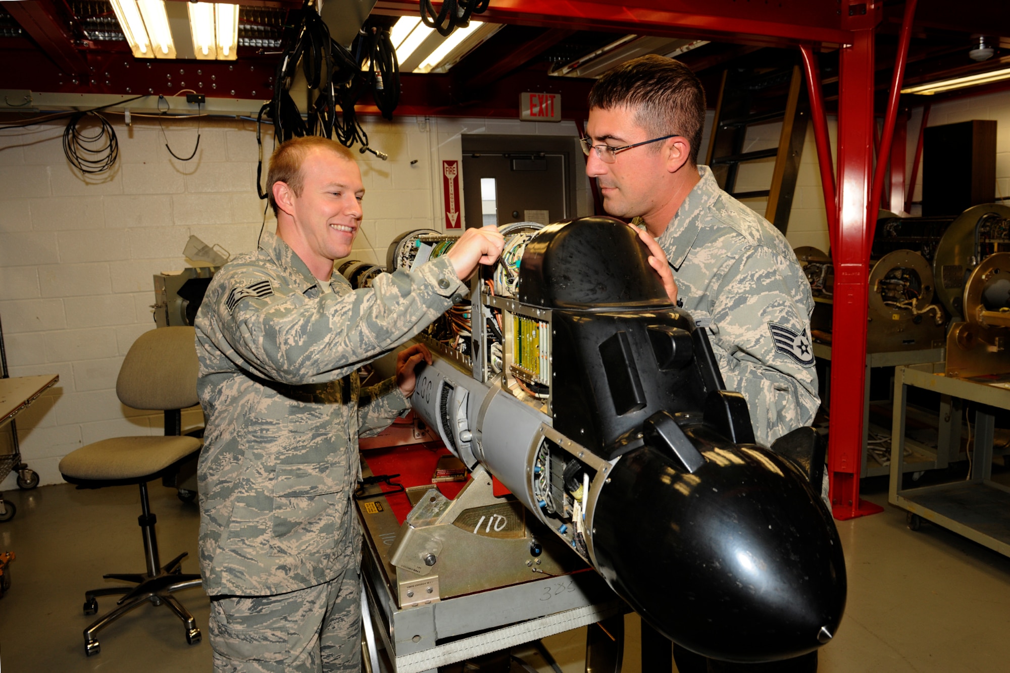 131102-Z-EZ686-263 -- Staff Sgt. Damon Childers and Staff Sgt. Marcus Danis, electronic warfare technicians with the 127th Maintenance Squadron, inspect an AN/ALM Countermeasure Pod at Selfridge Air National Guard Base, Mich., Nov. 2, 2013. Childers and Marcus both said they find their work challenging and said they enjoy the work they do as part of the Michigan Air National Guard what they do. (U.S. Air National Guard photo by MSgt. David Kujawa / Released)