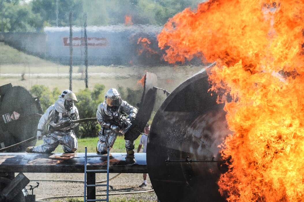 151st Air Refueling Wing firefighter, SMSgt. Todd Allen, left, leads a junior firefighter into the simulator at the 119th Regional Training Site in Fargo North Dakota during an annual training event on September 9, 2013. (U.S. Air Force photoby TSgt. Jeremy Giacoletto-Stegall)(RELEASED)