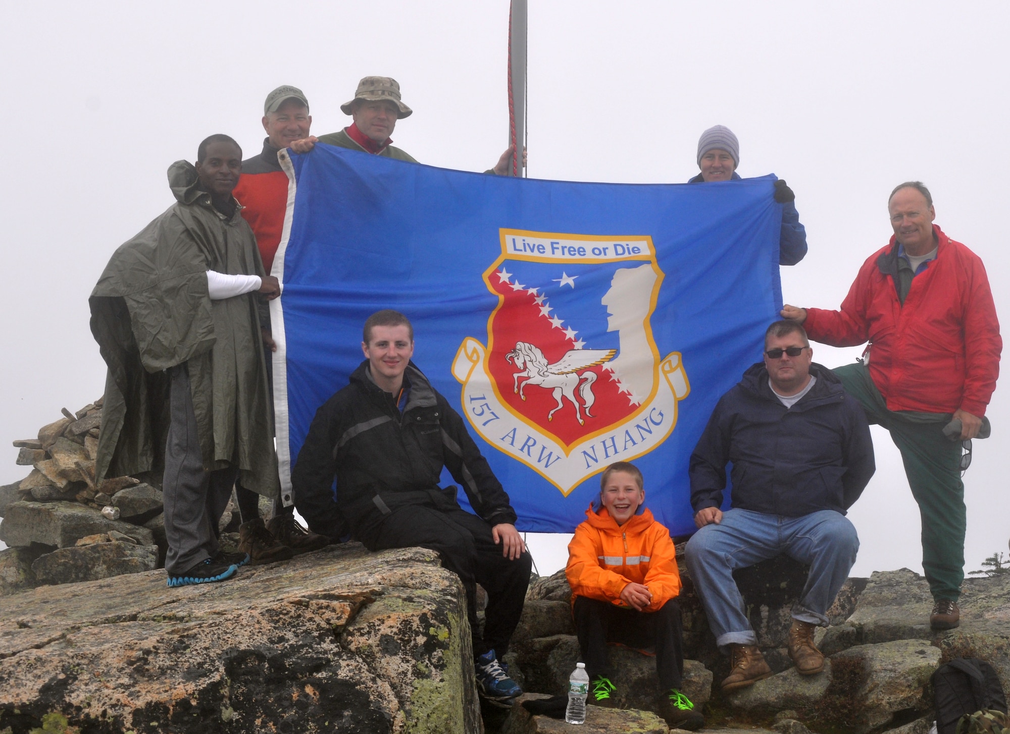 Members of the 157th Aircraft Maintenance Squadron pose for a photo during the annual Flags On The 48 event, Bond Cliff, Lincoln New Hampshire Sept. 14, 2013.   The event is a memorial hike to commemorate 9/11.  Pictured left to right: Senior Airman Sterling Howard, Chief Master Sgt. Scott Taatjes, Lt. Col. Adam Shattuck, Senior Airman Christopher Ager, Steven Shattuck, Lisa Rogers (a hiker from Manchester, N.H.) Tech. Sgt. John Seguin, and Master Sgt. Richard Blais. (Courtesy photo Richard Blais)   
