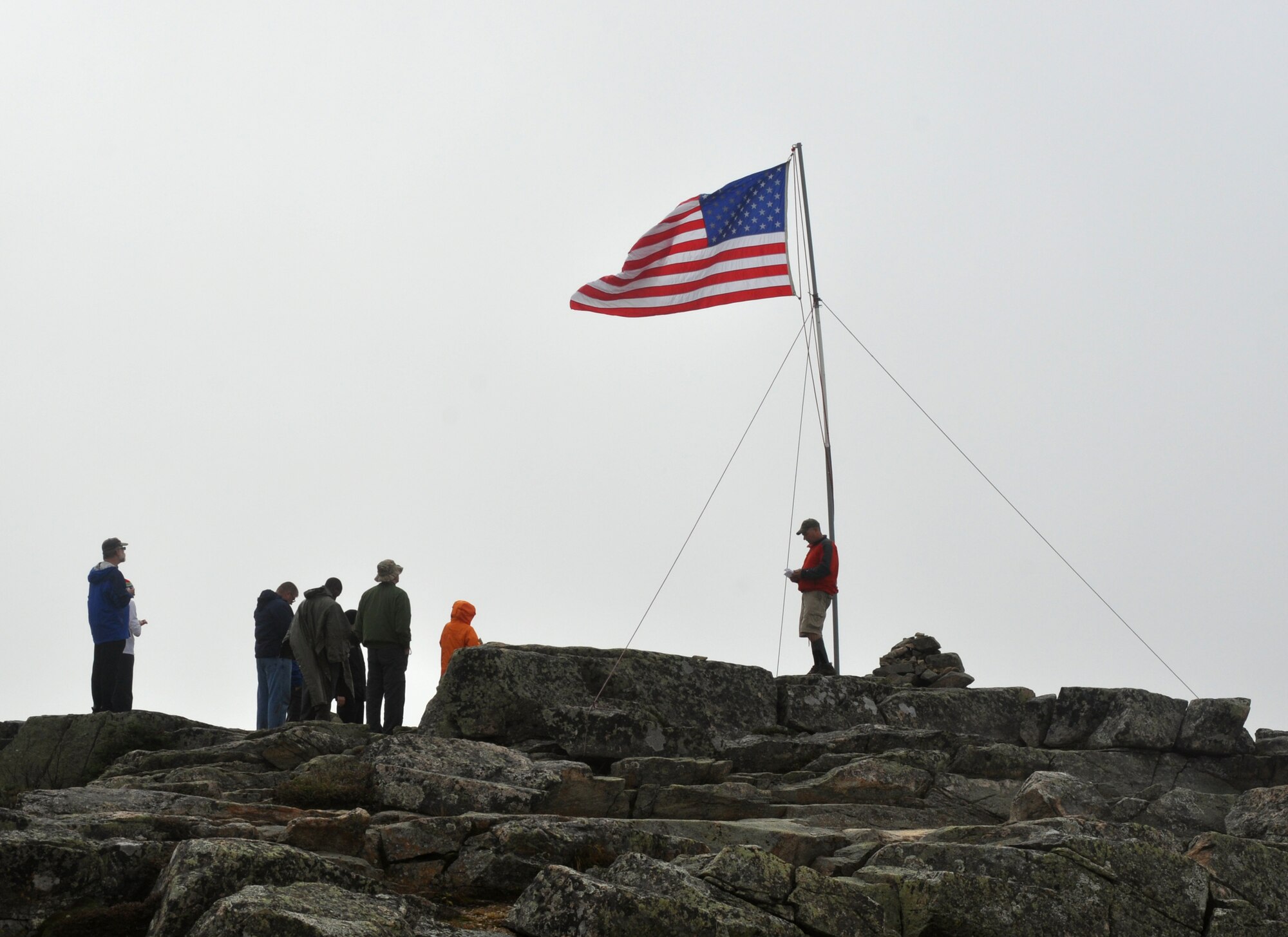 Chief Master Sgt. Scott Taatjes (center) recites a non-denominational prayer,  Bond Cliff, Lincoln, New Hampshire Sept. 14, 2013. The personnel, from the New Hampshire Air National Guard’s 157th Air Refueling Wing participated in the annual Flags On The 48 event which is s memorial hike to commemorate 9/11.  (Courtesy photo Richard Blais)  