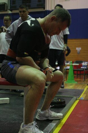 Abe Roman, overall male winner, focuses himself before attempting to bench press 374 pounds during the 2012 open bench press competition at the Ironworks Gym sports courts here Jan. 21. Roman has been an active lifter for more than 30 years. He credits this to a consistent lifting habits and overall nutrition.
