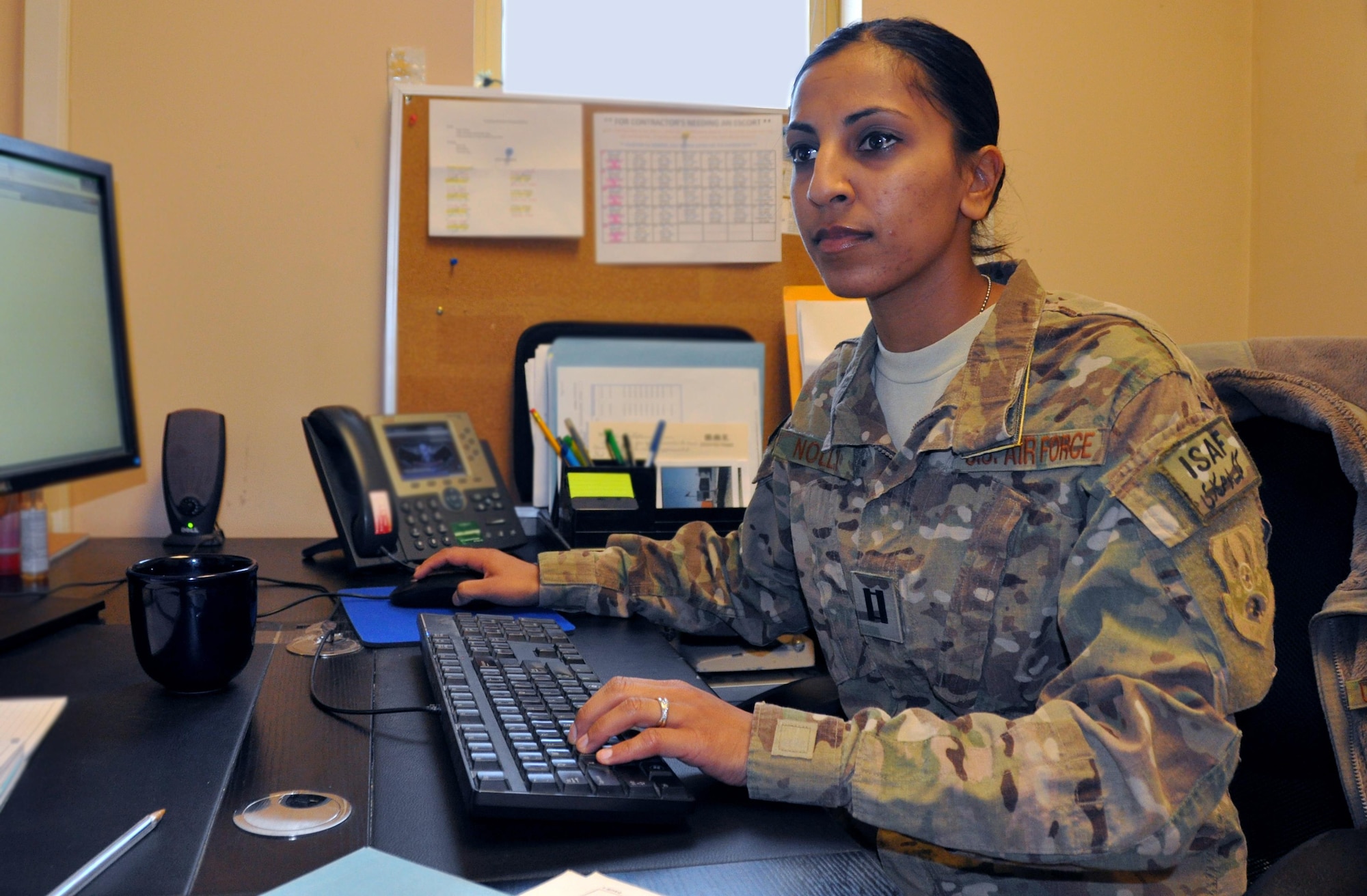 Capt. Dimple Nolly, 455th Air Expeditionary Wing deputy staff judge advocate, deployed from Spangdahlem Air Base, Germany, and a Houston native, works in her office at Bagram Airfield, Afghanistan, Oct. 29, 2013. 
