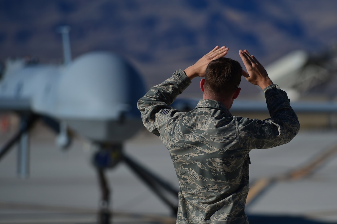 A crew chief from the 432nd Aircraft Maintenance Squadron taxis in an MQ-1 Predator remotely piloted aircraft during a post-flight inspection Nov. 1, 2013. Predators can perform the following missions and tasks: intelligence, surveillance, reconnaissance, close air support, combat search and rescue, precision strike, buddy-lase, convoy/raid overwatch, route clearance, target development, and terminal air guidance. The USAF’s MQ-9 Reaper and MQ-1 Predator fleet surpassed 2 million cumulative flight hours on Oct. 22, 2013.