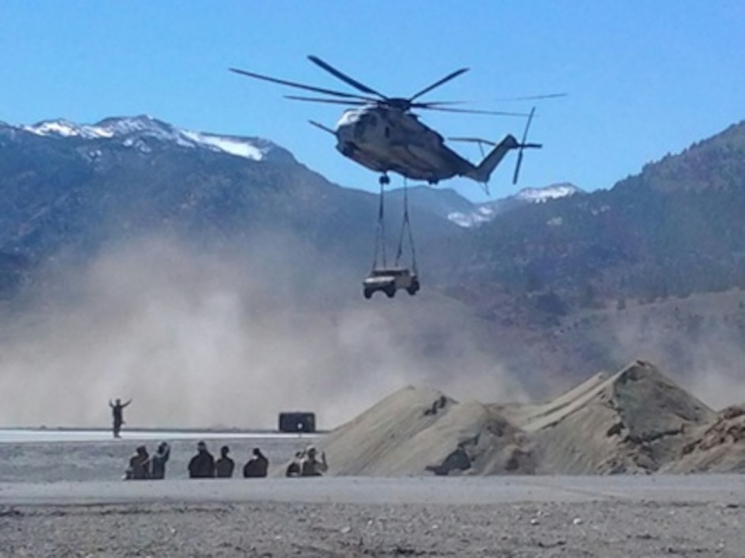 Marine Heavy Helicopter Squadron 466 conducts an external lift of a High Mobility Multipurpose Wheeled Vehicle with Landing Specialists from 1st Marine Logistics Group at Marine Corps Mountain Warfare Training Center  expeditionary airfield during Mountain Exercise 6-13.
