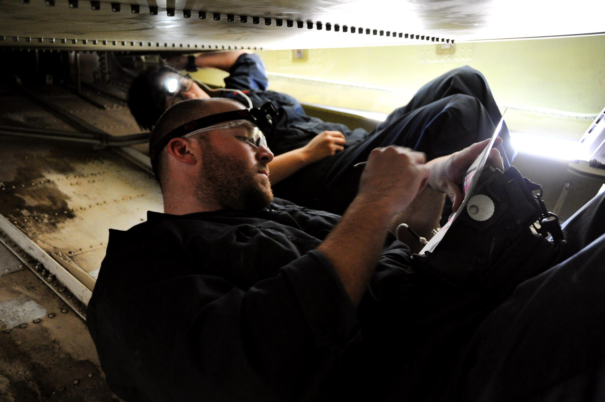 Tech. Sgt. Zach Williams and Airman 1st Class Felicia Ramirez, 349th Maintenance Squadron non-destructive inspection technicians, conduct an ultrasound on the metal surface inside the tail section of a KC-10 Extender Oct. 22 at Travis Air Force Base, Calif. 