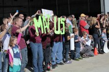 Friends and family of Marines from Marine Medium Tiltrotor Squadron 266 Reinforced eagerly wait for their Marines to arrive at Marine Corps Air Station New River during their homecoming ceremony, Nov. 4. This was the first time the Marines from VMM-266 (Rein.) saw their loved ones since they departed for the 26th Marine Expeditionary Unit 26, 8 months ago.