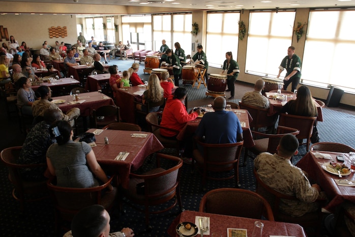 Station residents listen to the Department of Defense members give a Taiko drum performance along side Japanese civilians for Asian Pacific Islander Heritage Month at the Eagles Nest here May 31, 2012. DoD members playing beside Japanese civilians showed the common interest of music between these normally divergent communities.