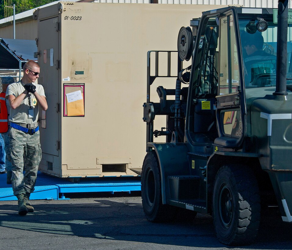 Airman 1st Class Joshua Mattlach, 15th Aircraft Maintenance Squadron guidance and control, left, gets his shipping documentation checked for accuracy by Micheal Kuklok, Naval Facilities Base Services Vehicle Equipment, cargo in-check lead, right, near the flightline during an Operational Readiness Inspection at Joint Base Pearl Harbor-Hickam, Hawaii, Nov. 3, 2013 The Consolidated Unit Inspection is designed to evaluated 15th Wing and 154th Wing capabilities to respond to real world contingencies.  (U.S. Air Force photo/Tech. Sgt. Jerome Tayborn)