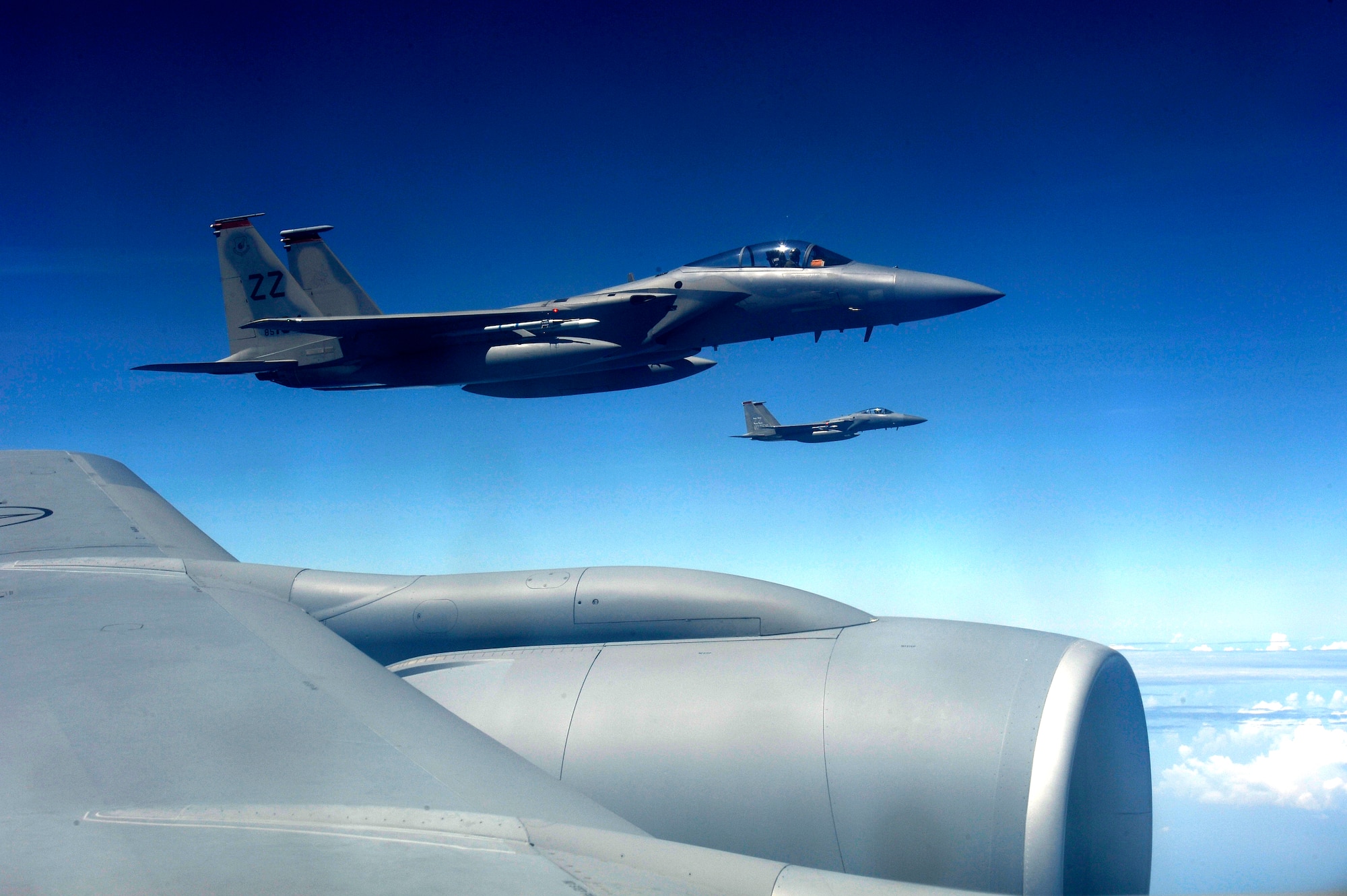 Two U.S. Air Force F-15 Eagles from the 67th Fighter Squadron fly in formation alongside a KC-135 Stratotanker aerial refueling aircraft over the Pacific Ocean as they return to Kadena Air Base, Japan, Oct. 29, 2013. For more than three weeks, six F-15s from the 67th FS trained with the Republic of Singapore air force to improve international cohesion and further develop allied partnerships for the security of the Asia-Pacific region. (U.S. Air Force photo by Senior Airman Maeson L. Elleman)
