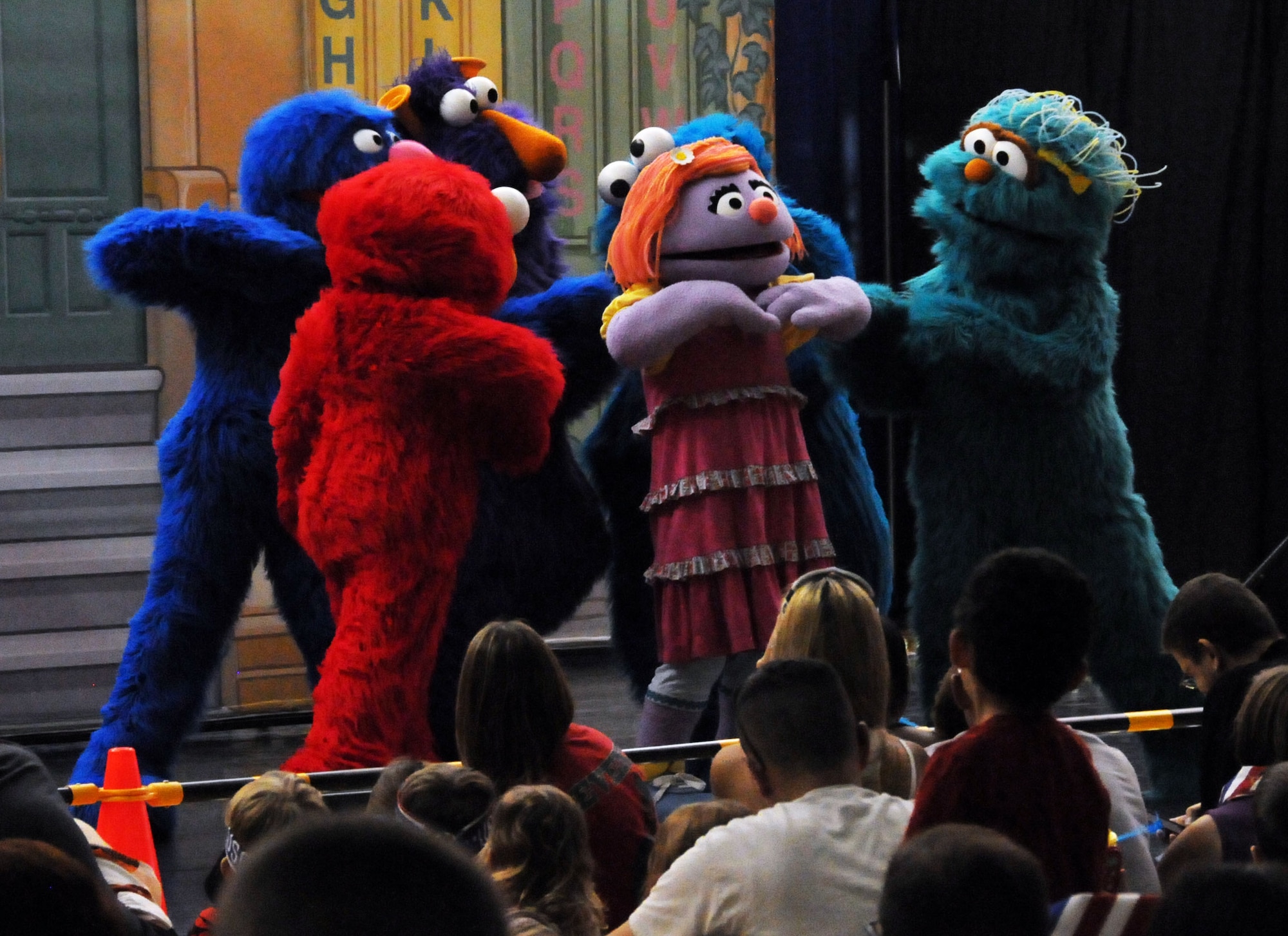Katie, a Sesame Street character, seeks comfort from her friends during the Sesame Street United Service Organizations Experience for Military Families performance Nov. 2, 2013, on Andersen Air Force Base, Guam. The tour showcased friendship when the Sesame Street gang helped Katie open up about her fears and excitement about moving to a new base and making new friends. (U.S. Air Force photo by Airman 1st Class Amanda Morris/Released)