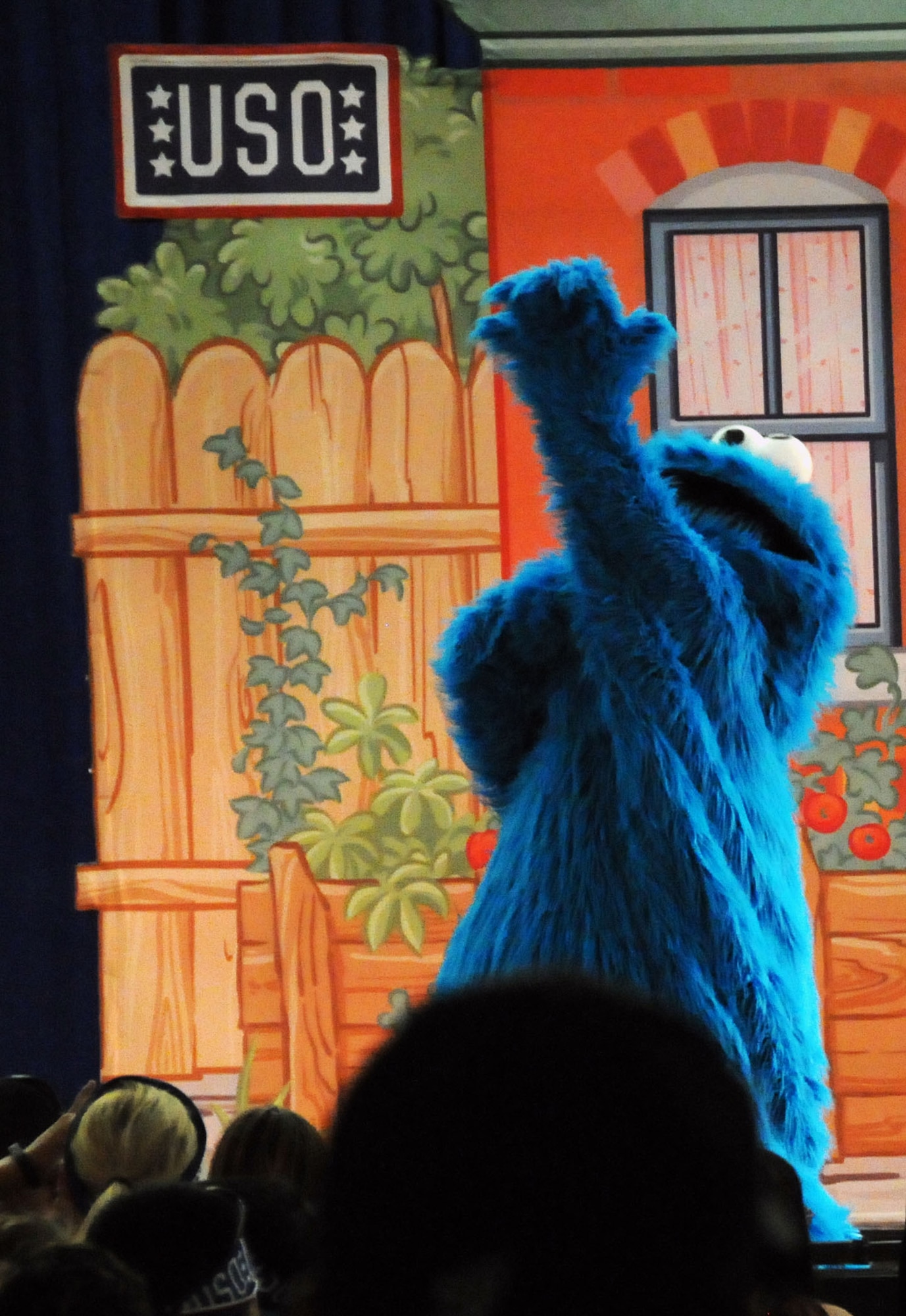 Cookie Monster, a Sesame Street character, sings for the crowd during a Sesame Street United Service Organizations Experience for Military Families performance Nov. 2, 2013, on Andersen Air Force Base, Guam. The tour celebrated five years touring the globe by traveling to 42 installations in eight countries in the Europe and Pacific regions. (U.S. Air Force photo by Airman 1st Class Amanda Morris/Released)